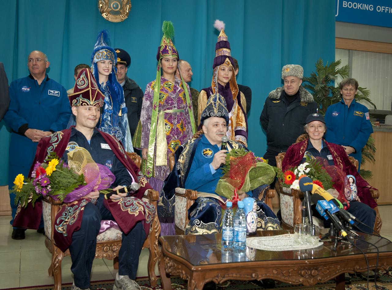 Seated from left,  Expedition 25 Commander Doug Wheelock and Flight Engineers Fyodor Yurchikhin and Shannon Walker talk during during a press conference after being greeting back to Earth by girls in traditional Kazakhstan at the Kostanay, Kazakhstan airport on Friday, Nov. 26, 2010.  Russian Cosmonaut Yurchikhin and NASA Astronauts Wheelock and Walker, landed in their Soyuz TMA-19 spacecraft outside the town of Arkalyk, Kazakhstan after nearly six months onboard the International Space Station where they served as members of the Expedition 24 and 25 crews. Photo Credit: (NASA/Bill Ingalls)