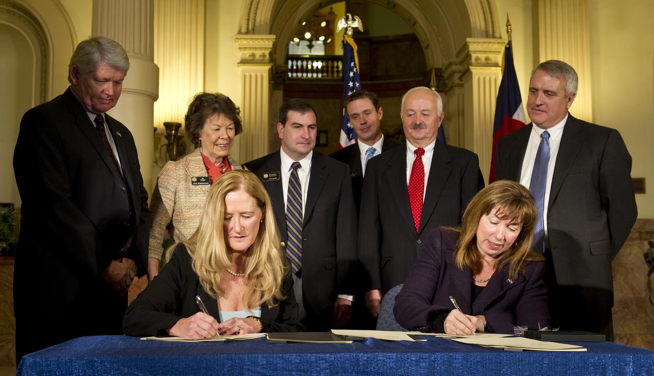 Colorado Association for Manufacturing and Technology (CAMT) CEO Elaine Thorndike, seated left, and NASA Deputy Administrator Lori Garver, seated right, sign an agreement at the Colorado State Capitol in Denver on Monday, Dec. 13, 2010, that created a Technology Acceleration Program and Regional Innovation Cluster for Aerospace and Clean Energy. Looking on from left, Executive Director, Colorado Office of Economic Development and International Trade Don Marostica, Colorado State Representative Su Ryden, Colorado State Senate President Brandon Schaffer, Representative from U.S. Senator Udall's office Jimmy Haugue, NIST/MEP Director Roger Kilmer and Colorado State Governor Bill Ritter. A manufacturing park focused on rapid new product development and production will be developed to assist growing Colorado businesses while promoting the commercialization of technology developed for the space program. Photo Credit: (NASA/Bill Ingalls)