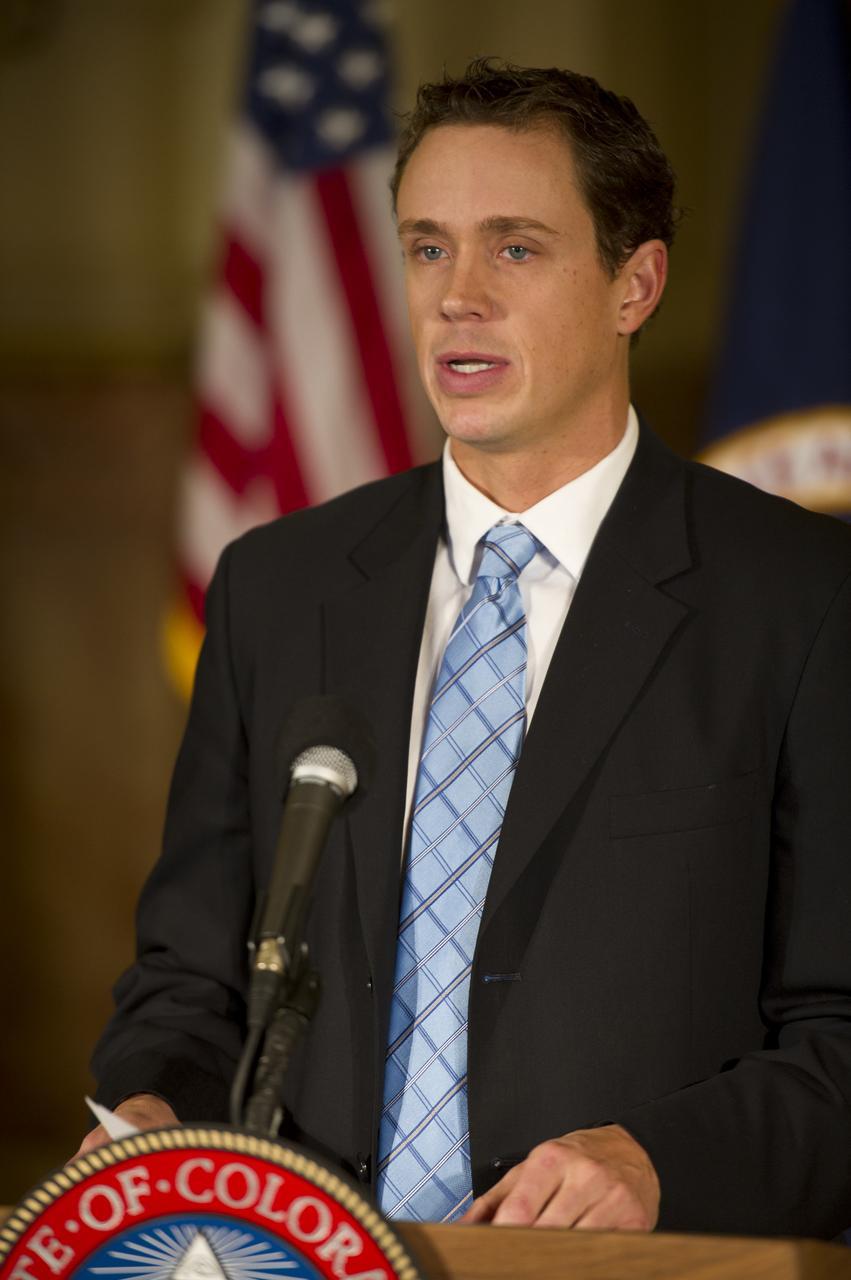 Representative from U.S. Senator Udall's office Jimmy Haugue reads remarks from U.S. Senator Udall at the Colorado State Capitol in Denver on Monday, Dec. 13, 2010, prior to the signing of an agreement with NASA that creates a Technology Acceleration Program and Regional Innovation Cluster for Aerospace and Clean Energy. A manufacturing park focused on rapid new product development and production will be developed to assist growing Colorado businesses while promoting the commercialization of technology developed for the space program. Photo Credit: (NASA/Bill Ingalls)