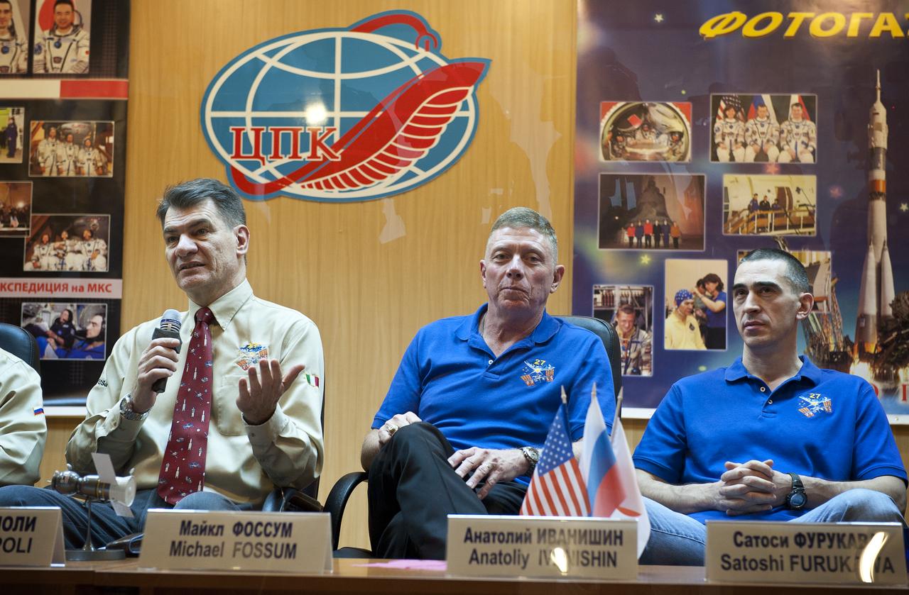 Italian astronaut Paolo Nespoli, Expedition 26 Flight Engineer, left, answers a question as Michael Fossum, Expedition 26 back up crew member and Anatoly Ivanishin, Expedition 26 back up crew member, right, look on during the State Commission press conference held at the Cosmonaut Hotel in Baikonur, Kazakhstan on Tuesday, Dec. 14, 2010. Photo Credit: (NASA/Carla Cioffi)