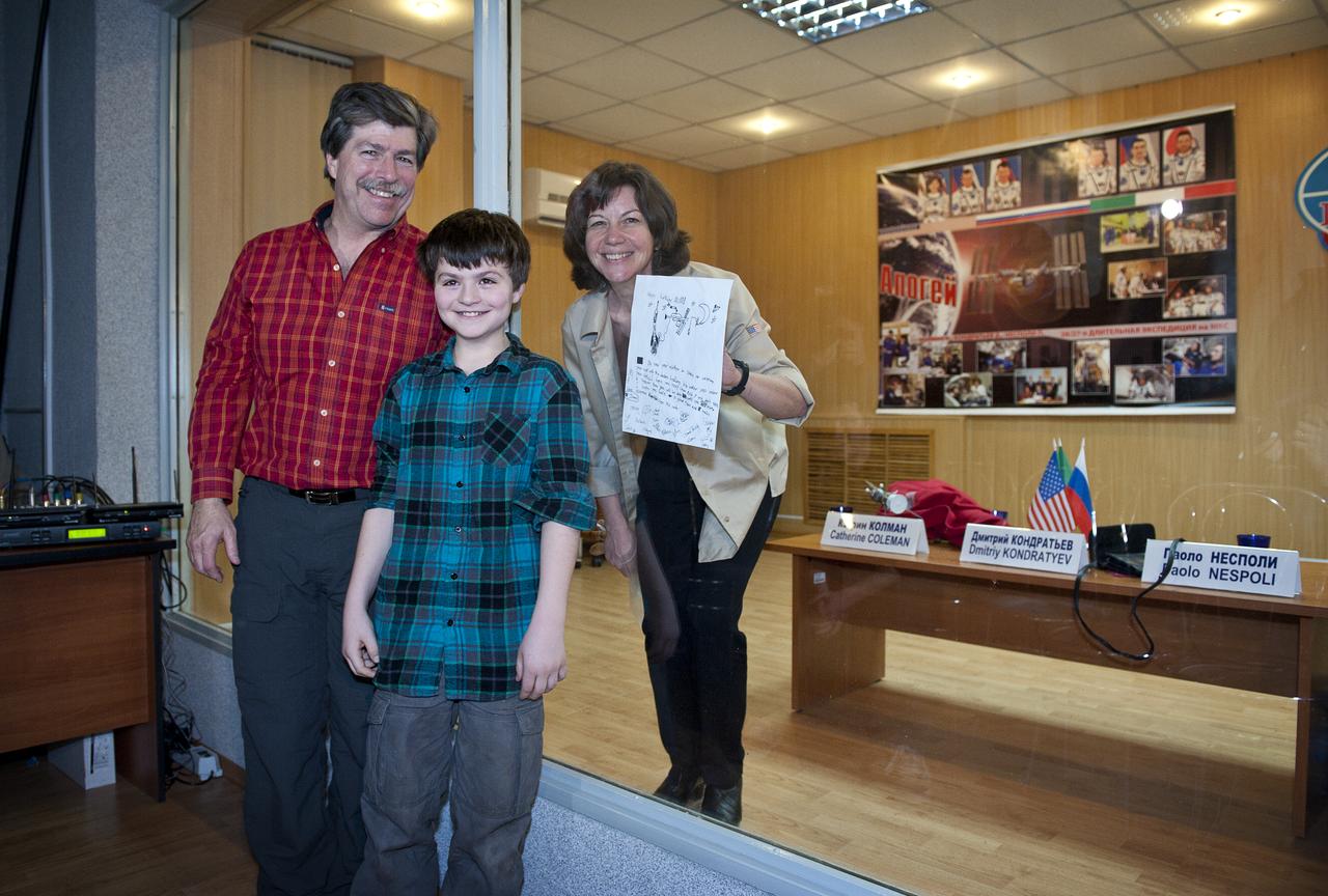 Catherine Coleman, NASA Flight Engineer, right, poses with her husband Josiah Simpson and son Jamey Simpson following the State Commission press conference held at the Cosmonaut Hotel in Baikonur, Kazakhstan on Tuesday, Dec. 14, 2010.  Photo Credit: (NASA/Carla Cioffi)