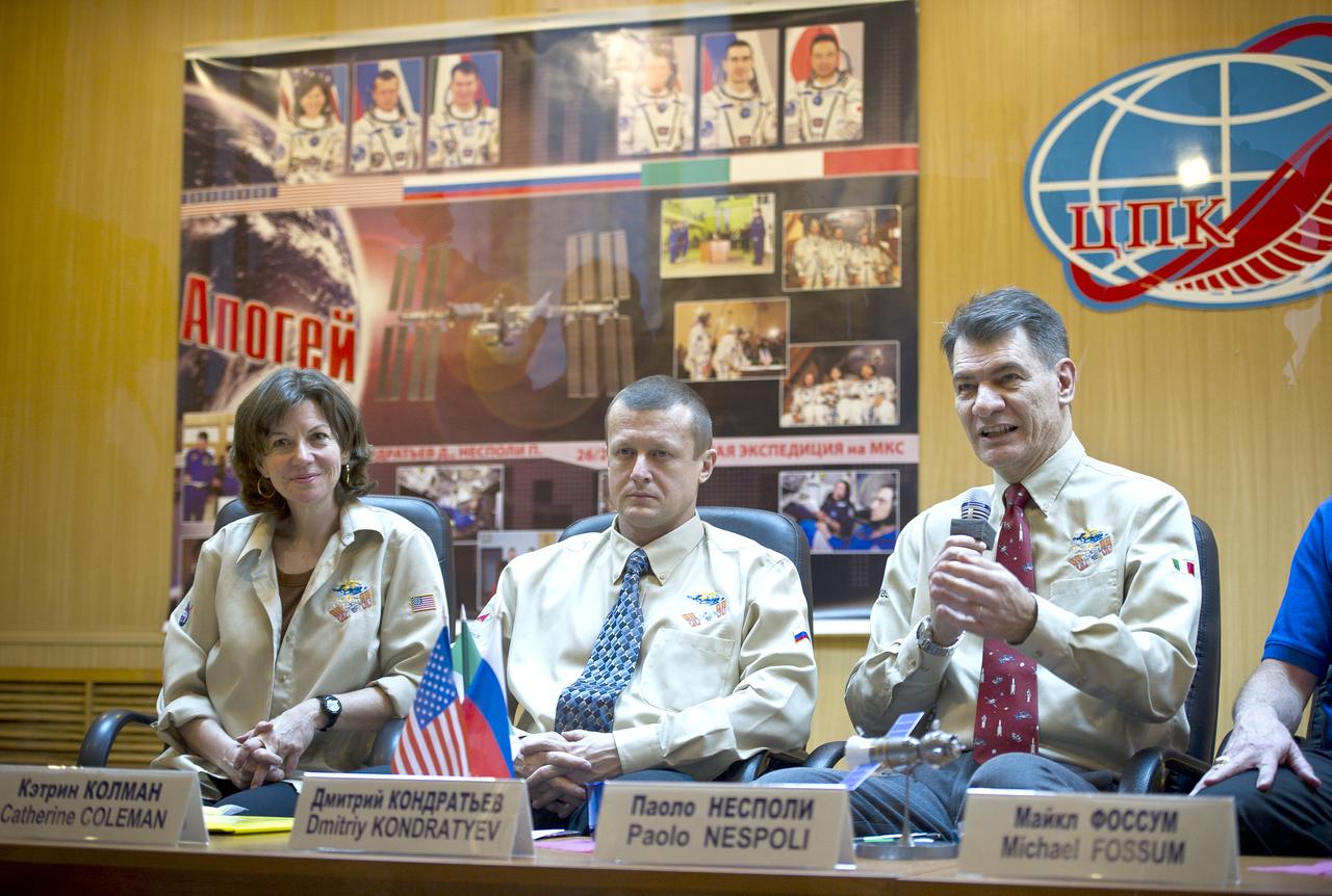 Expedition 26 Flight Engineer Paolo Nespoli, right, speaks at the State Commission press conference held at the Cosmonaut Hotel in Baikonur, Kazakhstan on Tuesday, Dec. 14, 2010, as Soyuz Commander Dmitry Kondratyev and Expedition 26 Flight Engineer Catherine Coleman look on. Photo Credit: (NASA/Carla Cioffi)