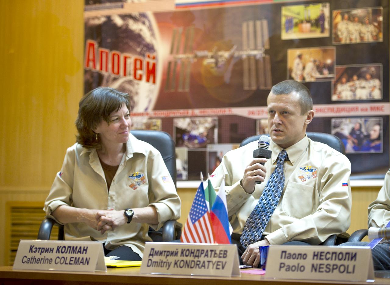 Expeditionn 26 Soyuz Commander Dmitry Kondratyev, right, speaks as Expedition 26 Flight Engineer Catherine Coleman looks on at the State Commission press conference held at the Cosmonaut Hotel in Baikonur, Kazakhstan on Tuesday, Dec. 14, 2010. Photo Credit: (NASA/Carla Cioffi)