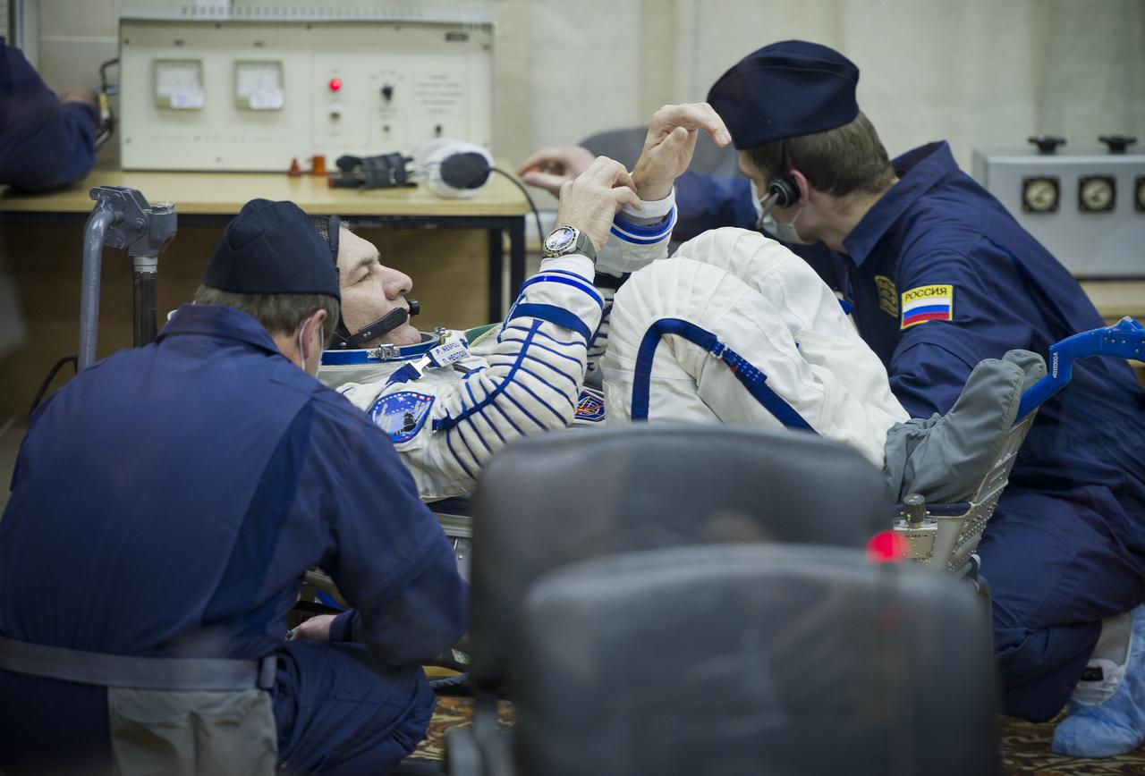 Expedition 26 European Space Agency astronaut Paolo Nespoli has his Russian Sokol suit pressure checked at the Baikonur Cosmodrome in Baikonur, Kazakhstan, Wednesday, Dec. 15, 2010. Nespoli and fellow Expedition 26 crew members Soyuz Commander Dmitry Kondratryev and NASA Flight Engineer Catherine Coleman launched in their Soyuz TMA-20 rocket from the Baikonur Cosmodrome in Kazakhstan the following morning at 1:09 a.m. local time. (Photo Credit: NASA/Carla Cioffi)