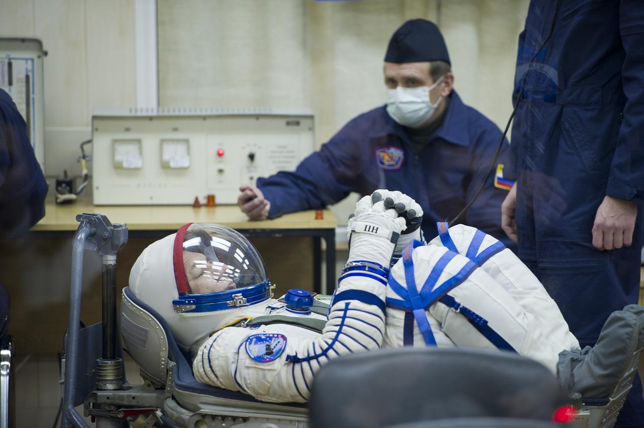 Expedition 26 European Space Agency astronaut Paolo Nespoli has his Russian Sokol suit pressure checked at the Baikonur Cosmodrome in Baikonur, Kazakhstan, Wednesday, Dec. 15, 2010. Nespoli and fellow Expedition 26 crew members Soyuz Commander Dmitry Kondratryev and NASA Flight Engineer Catherine Coleman launched in their Soyuz TMA-20 rocket from the Baikonur Cosmodrome in Kazakhstan the following morning at 1:09 a.m. local time. (Photo Credit: NASA/Carla Cioffi)