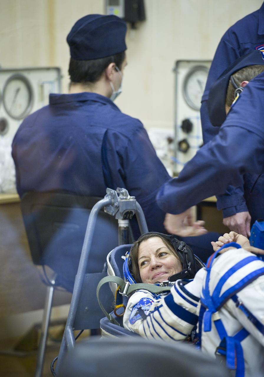 Expedition 26 NASA Flight Engineer Catherine Coleman has her Russian Sokol suit pressure checked prior to her launch at the Baikonur Cosmodrome Wednesday, Dec. 15, 2010 in Kazakhstan. Coleman and fellow Expedition 26 crew members Soyuz Commander Dmitry Kondratryev and ESA Flight Engineer Paolo Nespoli launched in their Soyuz TMA-20 rocket from the Baikonur Cosmodrome in Kazakhstan the following morning at 1:09 a.m. local time. (Photo Credit: (NASA/Carla Cioffi)