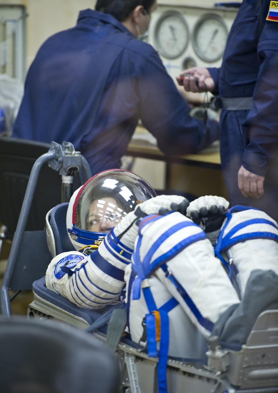Expedition 26 NASA Flight Engineer Catherine Coleman has her Russian Sokol suit pressure checked prior to her launch at the Baikonur Cosmodrome Wednesday, Dec. 15, 2010 in Kazakhstan. Coleman and fellow Expedition 26 crew members Soyuz Commander Dmitry Kondratryev and ESA Flight Engineer Paolo Nespoli launched in their Soyuz TMA-20 rocket from the Baikonur Cosmodrome in Kazakhstan the following morning at 1:09 a.m. local time. (Photo Credit: (NASA/Carla Cioffi)