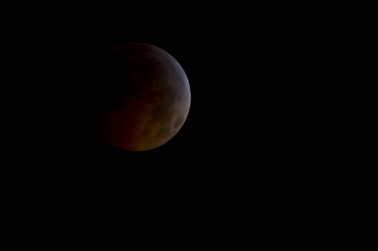 A total lunar eclipse is seen as the full moon is shadowed by the Earth on the arrival of the winter solstice, Tuesday, December 21, 2010 in Arlington, VA.  From beginning to end, the eclipse will last about three hours and twenty-eight minutes.  Photo Credit: (NASA/Bill Ingalls)