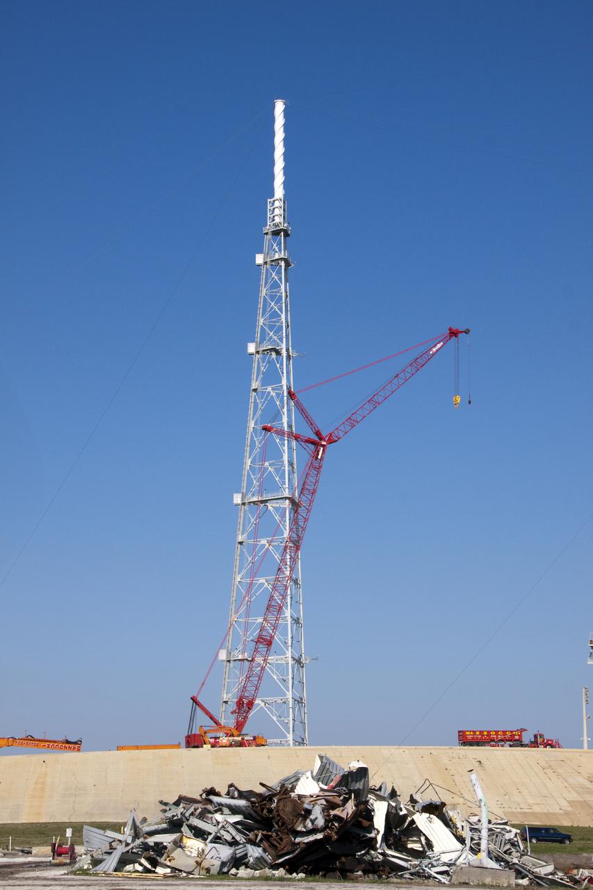 CAPE CANAVERAL, Fla. -- At NASA's Kennedy Space Center in Florida, a large crane will assist in the removal of Launch Pad 39B's fixed service structure FSS. Removal of the pad's rotating service structure RSS continues. The FSS and RSS were designed to support the unique needs of the Space Shuttle Program. In 2009, the pad was no longer needed for the shuttle program, so it is being restructured for future use.   Its new design will feature a 'clean pad' for rockets to come with their own launcher, making it more versatile for a number of vehicles. The transformation also includes the refurbishment of the liquid oxygen and liquid hydrogen tanks and the upgrade of about 1.3 million feet of cable. The new lightning protection system, which was in place for the October 2009 launch of Ares I-X, will remain. For information on NASA's future plans, visit www.nasa.gov. Photo credit: NASA_Troy Cryder