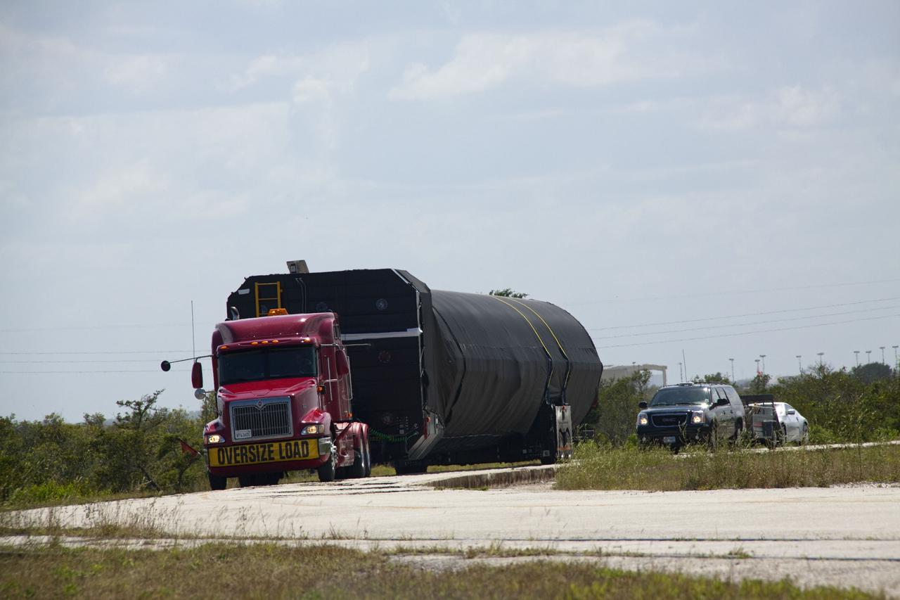 CAPE CANAVERAL, Fla. -- The first stage of the SpaceX COTS-2 Falcon 9 rocket is being transported to a SpaceX hangar at Pad 40 at Cape Canaveral Air Force Station in Florida.       Once assembled, it will be a two-stage fully integrated launch vehicle, consisting of a first stage powered by nine SpaceX-developed Merlin 1C engines, a second stage, an interstage, an unpressurized trunk and the Dragon spacecraft qualification unit. SpaceX was awarded procurement for three demonstration flights under the Commercial Orbital Transportation Services, or COTS, program managed by NASA's Johnson Space Center in Houston. A subsequent contract for Commercial Resupply Services, or CRS, was awarded in late 2008 to resupply the International Space Station. The SpaceX CRS contract provides for 12 missions to resupply the station from 2011 through 2015. Photo credit: NASA_Jack Pfaller