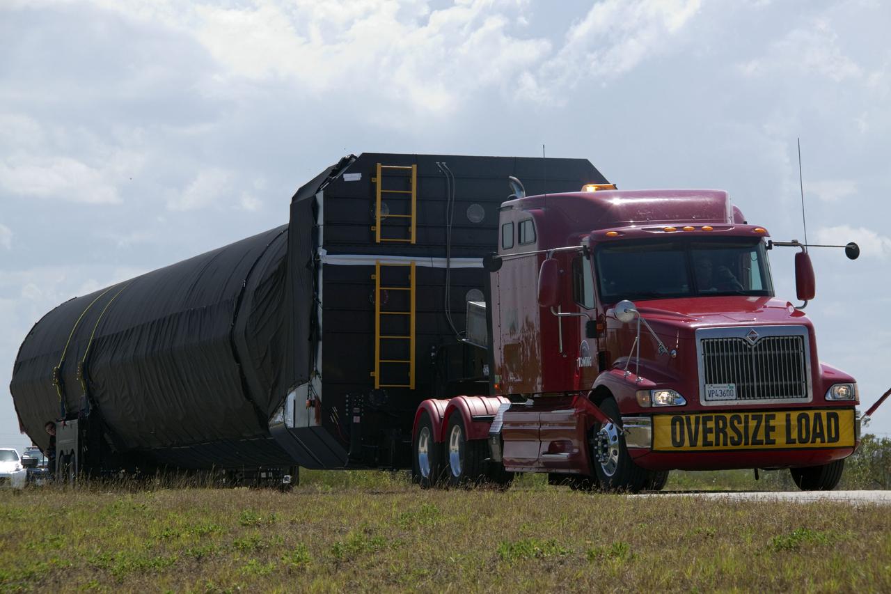 CAPE CANAVERAL, Fla. -- The first stage of the SpaceX COTS-2 Falcon 9 rocket is being transported to a SpaceX hangar at Pad 40 at Cape Canaveral Air Force Station in Florida.       Once assembled, it will be a two-stage fully integrated launch vehicle, consisting of a first stage powered by nine SpaceX-developed Merlin 1C engines, a second stage, an interstage, an unpressurized trunk and the Dragon spacecraft qualification unit. SpaceX was awarded procurement for three demonstration flights under the Commercial Orbital Transportation Services, or COTS, program managed by NASA's Johnson Space Center in Houston. A subsequent contract for Commercial Resupply Services, or CRS, was awarded in late 2008 to resupply the International Space Station. The SpaceX CRS contract provides for 12 missions to resupply the station from 2011 through 2015. Photo credit: NASA_Jack Pfaller