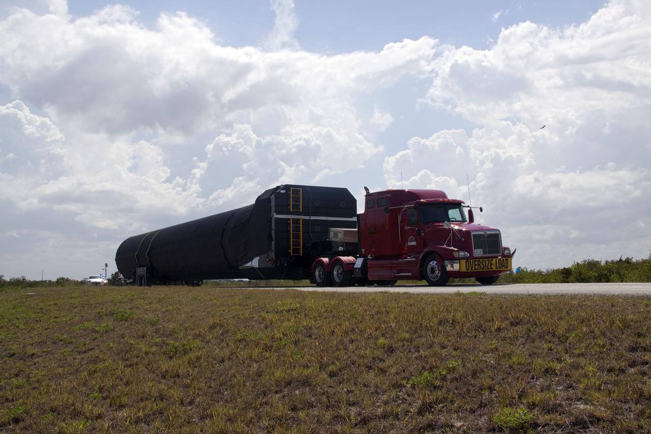 CAPE CANAVERAL, Fla. -- The first stage of the SpaceX COTS-2 Falcon 9 rocket is being transported to a SpaceX hangar at Pad 40 at Cape Canaveral Air Force Station in Florida.       Once assembled, it will be a two-stage fully integrated launch vehicle, consisting of a first stage powered by nine SpaceX-developed Merlin 1C engines, a second stage, an interstage, an unpressurized trunk and the Dragon spacecraft qualification unit. SpaceX was awarded procurement for three demonstration flights under the Commercial Orbital Transportation Services, or COTS, program managed by NASA's Johnson Space Center in Houston. A subsequent contract for Commercial Resupply Services, or CRS, was awarded in late 2008 to resupply the International Space Station. The SpaceX CRS contract provides for 12 missions to resupply the station from 2011 through 2015. Photo credit: NASA_Jack Pfaller