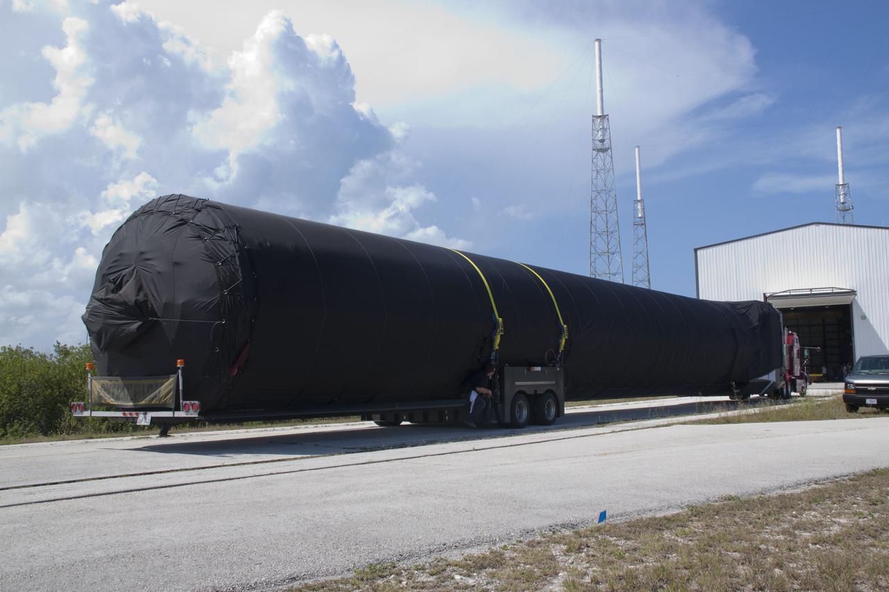 CAPE CANAVERAL, Fla. -- The first stage of the SpaceX COTS-2 Falcon 9 rocket is being transported to a SpaceX hangar at Pad 40 at Cape Canaveral Air Force Station in Florida.       Once assembled, it will be a two-stage fully integrated launch vehicle, consisting of a first stage powered by nine SpaceX-developed Merlin 1C engines, a second stage, an interstage, an unpressurized trunk and the Dragon spacecraft qualification unit. SpaceX was awarded procurement for three demonstration flights under the Commercial Orbital Transportation Services, or COTS, program managed by NASA's Johnson Space Center in Houston. A subsequent contract for Commercial Resupply Services, or CRS, was awarded in late 2008 to resupply the International Space Station. The SpaceX CRS contract provides for 12 missions to resupply the station from 2011 through 2015. Photo credit: NASA_Jack Pfaller