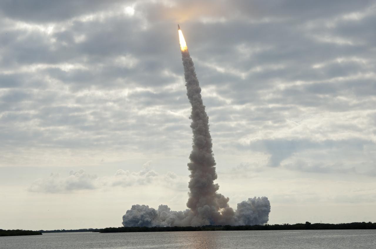 CAPE CANAVERAL, Fla. - Seen from across the Banana River Creek Viewing Site near the Saturn V Center, space shuttle Endeavour soars skyward. The shuttle lifted off on its STS-134 mission to the International Space Station on time at 8:56 a.m. EDT on May 16 from Launch Pad 39A at NASA's Kennedy Space Center in Florida. The shuttle and its six-member crew are embarking on a mission to deliver the Alpha Magnetic Spectrometer-2 (AMS), Express Logistics Carrier-3, a high-pressure gas tank and additional spare parts for the Dextre robotic helper to the space station. Endeavour's first launch attempt on April 29 was scrubbed because of an issue associated with a faulty power distribution box called the aft load control assembly-2 (ALCA-2). For more information, visit www.nasa.gov_mission_pages_shuttle_shuttlemissions_sts134_index.html. Photo credit: NASA_Chad Baumer
