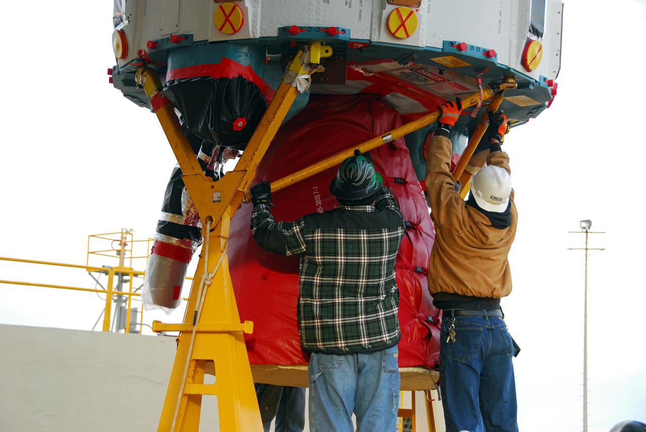 VANDENBERG AIR FORCE BASE, Calif. -- Workers guide the first stage of the United Launch Alliance Delta II rocket that will carry the Aquarius_SAC-D spacecraft into low Earth orbit onto the service tower at NASA's Space Launch Complex-2 (SLC-2) at Vandenberg Air Force Base in California.       Following final tests, the spacecraft will be integrated to the Delta II in preparation for the targeted June launch. Aquarius, the NASA-built instrument on the SAC-D spacecraft, on its three-year mission, will provide new insights into how variations in ocean surface salinity relate to fundamental climate processes. Photo credit: NASA_VAFB