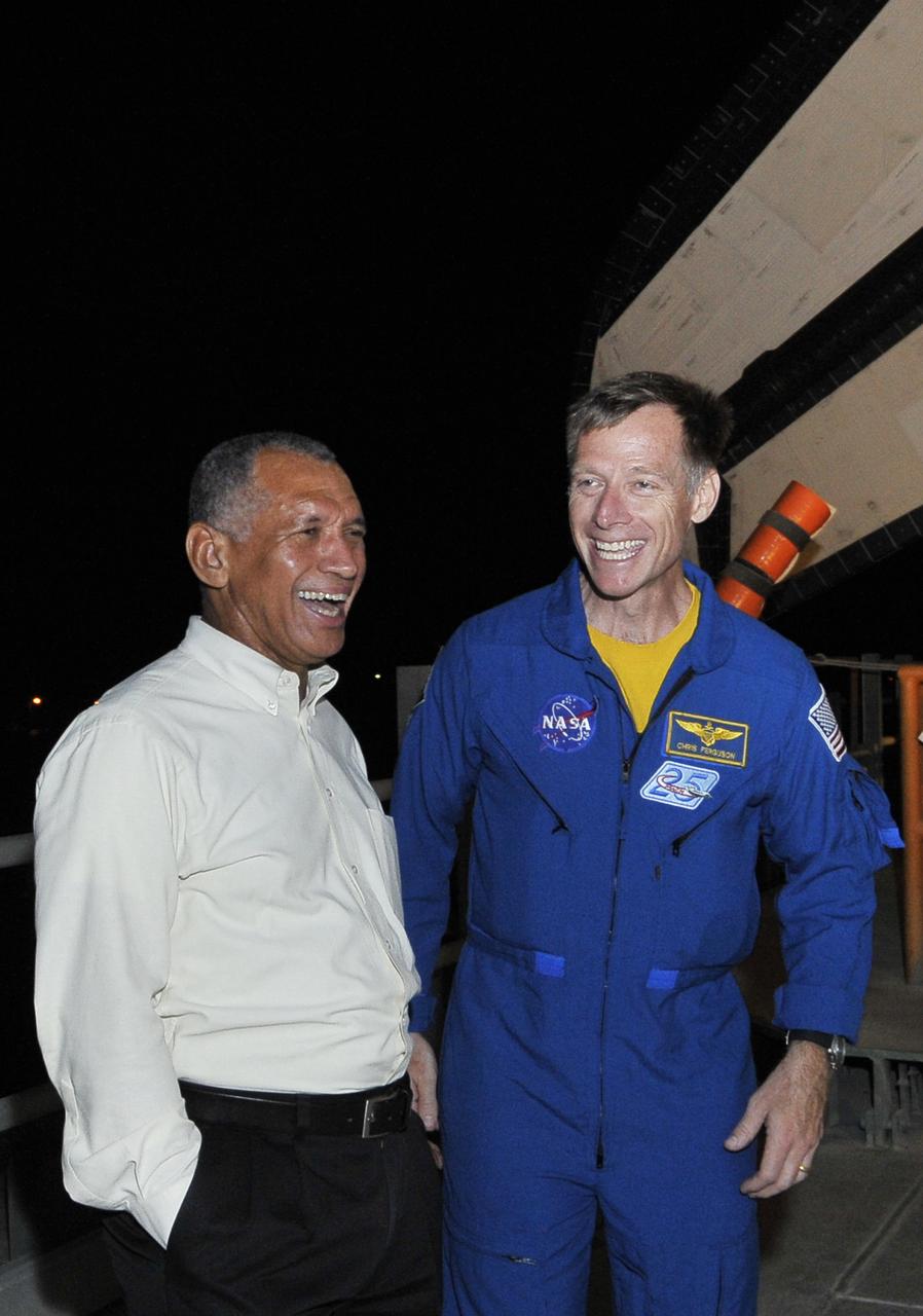 Kennedy Space Center Director Charley Bolden laughs  at a story being told to him by  STS-135 crew Commander Chris Ferguson during rollout of Shuttle Atlantis on the Mobil Launch Platform (MLP) at Kennedy Space Center, Cape Canaveral, Florida, USA 31 May 2011. Launch of Atlantis on the STS-135 mission to deliver supplies to the International Space Station is currently planned for no earlier than 08 July 2011. The STS-135 mission is  planned to last eight days and will be the final flight of the Space Shuttle program.