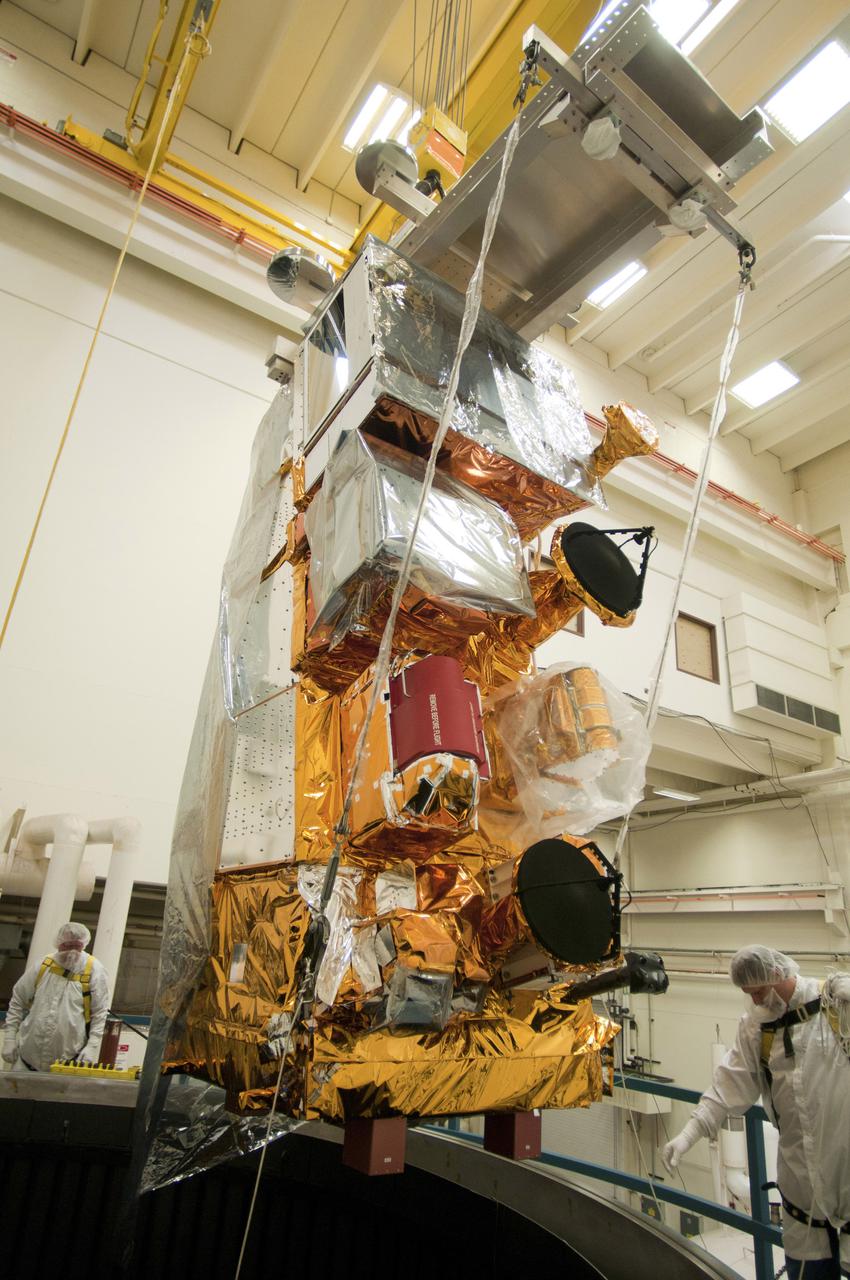 BALL AEROSPACE, Boulder, Colo. – In a cleanroom at Ball Aerospace and Technologies Corp., NASA's National Polar-orbiting Operational Environmental Satellite System Preparatory Project (NPP) satellite, with all systems integrated, is being lowered by technicians into a thermal vacuum chamber for testing. A United Launch Alliance Delta II rocket will carry NPP into space.  NPP represents a critical first step in building the next-generation of Earth-observing satellites. NPP will carry the first of the new sensors developed for this satellite fleet, now known as the Joint Polar Satellite System (JPSS) to be launched in 2016. NPP is the bridge between NASA's Earth Observing System (EOS) satellites and the forthcoming series of JPSS satellites. The mission will test key technologies and instruments for the JPSS missions. NPP is targeted to launch Oct. 27. For more information, visit http:__www.nasa.gov_NPP. Photo credit: Ball Aerospace
