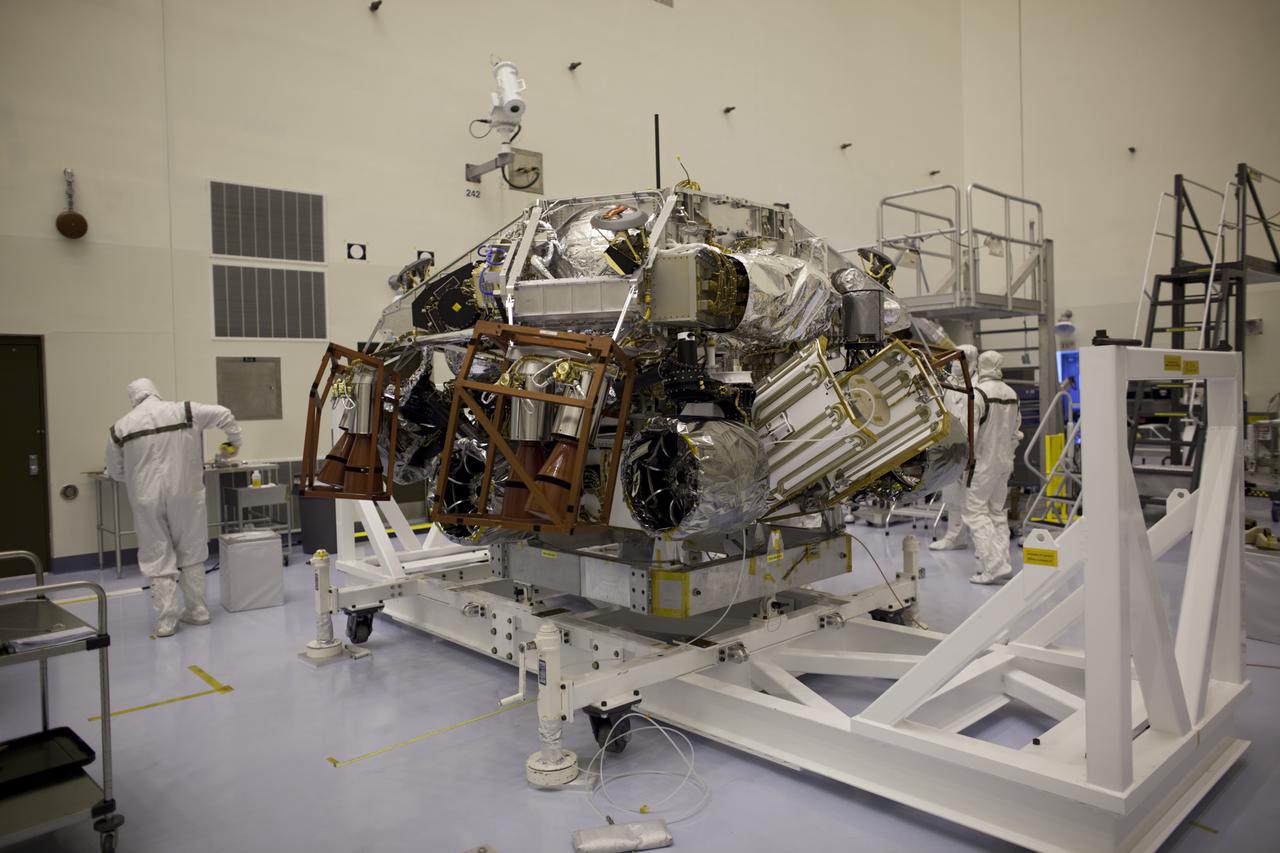 CAPE CANAVERAL, Fla. – In the Payload Hazardous Servicing Facility at NASA's Kennedy Space Center in Florida, technicians prepare the Mars Science Laboratory (MSL) rover, Curiosity, for encapsulation inside a backshell. The spacecraft's backshell, a protective cover, carries the parachute and several components used during later stages of entry, descent and landing of the MSL's rover. The rover has been integrated with a rocket-powered descent stage which will lower Curiosity to the surface of Mars. A United Launch Alliance Atlas V-541 configuration will be used to loft MSL into space. MSL's components include a compact car-sized rover, Curiosity, which has 10 science instruments designed to search for evidence on whether Mars has had environments favorable to microbial life, including chemical ingredients for life. The unique rover will use a laser to look inside rocks and release its gasses so that the rover’s spectrometer can analyze and send the data back to Earth. MSL is scheduled to launch Nov. 25 with a window extending to Dec. 18 and arrival at Mars Aug. 2012. For more information, visit http:__www.nasa.gov_msl. Photo credit: NASA_Dimitri Gerondidakis