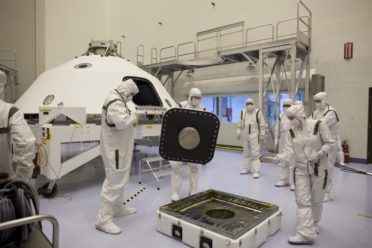 CAPE CANAVERAL, Fla. – In the Payload Hazardous Servicing Facility at NASA's Kennedy Space Center in Florida, technicians process the backshell for NASA's Mars Science Laboratory (MSL) rover, Curiosity. The backshell, a protective cover which carries the parachute and several components used during later stages of entry, descent and landing, will be encapsulated over the rover. A United Launch Alliance Atlas V-541 configuration will be used to loft MSL into space. MSL's components include a compact car-sized rover, Curiosity, which has 10 science instruments designed to search for evidence on whether Mars has had environments favorable to microbial life, including chemical ingredients for life. The unique rover will use a laser to look inside rocks and release its gasses so that the rover’s spectrometer can analyze and send the data back to Earth. MSL is scheduled to launch Nov. 25 with a window extending to Dec. 18 and arrival at Mars Aug. 2012. For more information, visit http:__www.nasa.gov_msl. Photo credit: NASA_Dimitri Gerondidakis