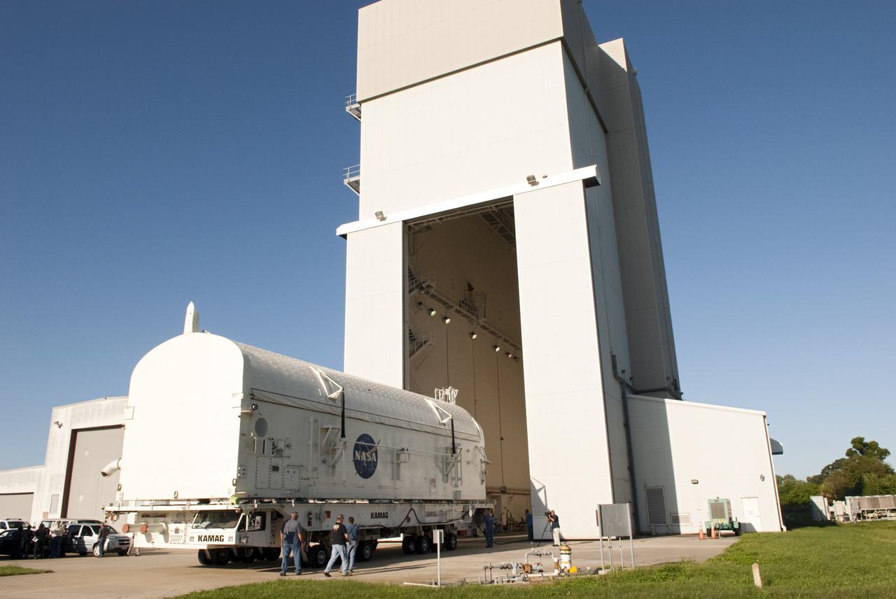 CAPE CANAVERAL, Fla. -- Payload canister #1 departs the high bay of the Canister Rotation Facility at NASA's Kennedy Space Center in Florida for the last time.  The canister is being moved to the Reutilization, Recycling and Marketing Facility on Ransom Road.  The two payload canisters used to transport space shuttle payloads to the launch pad for installation in the shuttles' cargo bays are being decommissioned following the end of the Space Shuttle Program. Each canister weighs 110,000 pounds and is 65 feet long, 22 feet wide, and 18 feet, 7 inches high.  The canisters were prescreened through NASA Headquarters as possible artifacts, but their size makes them difficult to transport to locations off the center. Federal and state agencies now will be given the opportunity to screen the canisters for potential use before a final decision is made on their disposition.  For more information, visit http:__www.nasa.gov_centers_kennedy_pdf_167403main_CRF-06.pdf. Photo credit: NASA_Jim Grossmann