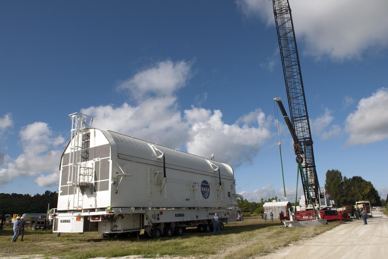CAPE CANAVERAL, Fla. -- Payload canister #1 arrives outside the Reutilization, Recycling and Marketing Facility on Ransom Road at NASA's Kennedy Space Center in Florida.  The two payload canisters used to transport space shuttle payloads to the launch pad for installation in the shuttles' cargo bays are being decommissioned following the end of the Space Shuttle Program. Each canister weighs 110,000 pounds and is 65 feet long, 22 feet wide, and 18 feet, 7 inches high.  The canisters were prescreened through NASA Headquarters as possible artifacts, but their size makes them difficult to transport to locations off the center. Federal and state agencies now will be given the opportunity to screen the canisters for potential use before a final decision is made on their disposition.  For more information, visit http:__www.nasa.gov_centers_kennedy_pdf_167403main_CRF-06.pdf. Photo credit: NASA_Jim Grossmann