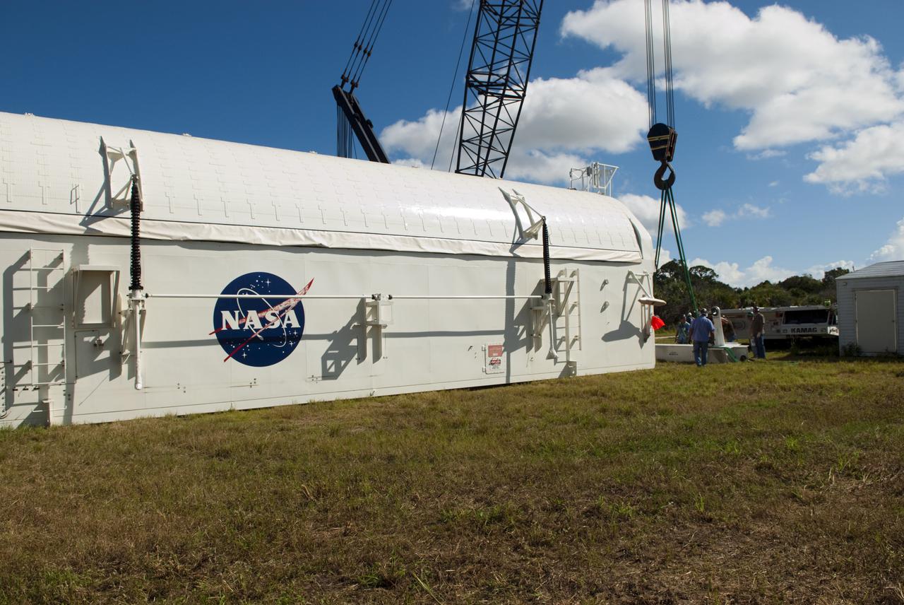 CAPE CANAVERAL, Fla. -- Payload canister #1 awaits decommissioning outside the Reutilization, Recycling and Marketing Facility on Ransom Road at NASA's Kennedy Space Center in Florida.   The two payload canisters used to transport space shuttle payloads to the launch pad for installation in the shuttles' cargo bays are being decommissioned following the end of the Space Shuttle Program. Each canister weighs 110,000 pounds and is 65 feet long, 22 feet wide, and 18 feet, 7 inches high.  The canisters were prescreened through NASA Headquarters as possible artifacts, but their size makes them difficult to transport to locations off the center. Federal and state agencies now will be given the opportunity to screen the canisters for potential use before a final decision is made on their disposition.  For more information, visit http:__www.nasa.gov_centers_kennedy_pdf_167403main_CRF-06.pdf. Photo credit: NASA_Jim Grossmann