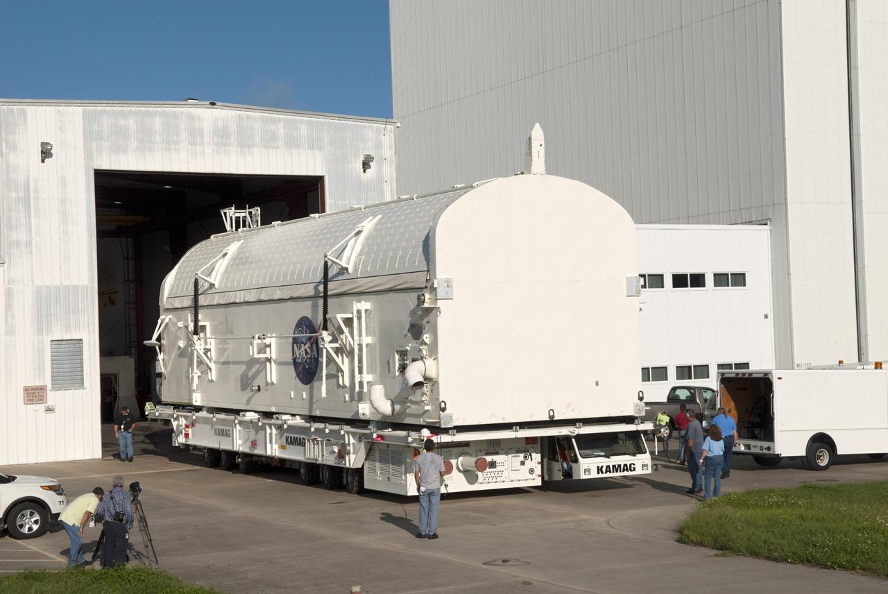 CAPE CANAVERAL, Fla. -- Employees monitor payload canister #2 as it rolls out of the high bay of the Canister Rotation Facility at NASA's Kennedy Space Center in Florida for its trip to the Reutilization, Recycling and Marketing Facility on Ransom Road.  The two payload canisters used to transport space shuttle payloads to the launch pad for installation in the shuttles' cargo bays are being decommissioned following the end of the Space Shuttle Program. Each canister weighs 110,000 pounds and is 65 feet long, 22 feet wide, and 18 feet, 7 inches high.  The canisters were prescreened through NASA Headquarters as possible artifacts, but their size makes them difficult to transport to locations off the center. Federal and state agencies now will be given the opportunity to screen the canisters for potential use before a final decision is made on their disposition.  For more information, visit http:__www.nasa.gov_centers_kennedy_pdf_167403main_CRF-06.pdf. Photo credit: NASA_Jim Grossmann