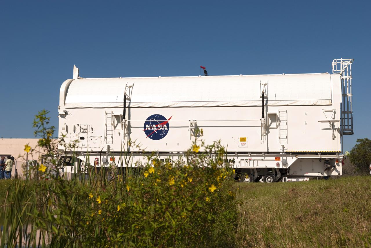 CAPE CANAVERAL, Fla. -- Wildflowers line the roadway along the route payload canister #2 is traveling between the Canister Rotation Facility and the Reutilization, Recycling and Marketing Facility on Ransom Road at NASA's Kennedy Space Center in Florida.   The two payload canisters used to transport space shuttle payloads to the launch pad for installation in the shuttles' cargo bays are being decommissioned following the end of the Space Shuttle Program. Each canister weighs 110,000 pounds and is 65 feet long, 22 feet wide, and 18 feet, 7 inches high.  The canisters were prescreened through NASA Headquarters as possible artifacts, but their size makes them difficult to transport to locations off the center. Federal and state agencies now will be given the opportunity to screen the canisters for potential use before a final decision is made on their disposition.  For more information, visit http:__www.nasa.gov_centers_kennedy_pdf_167403main_CRF-06.pdf. Photo credit: NASA_Jim Grossmann