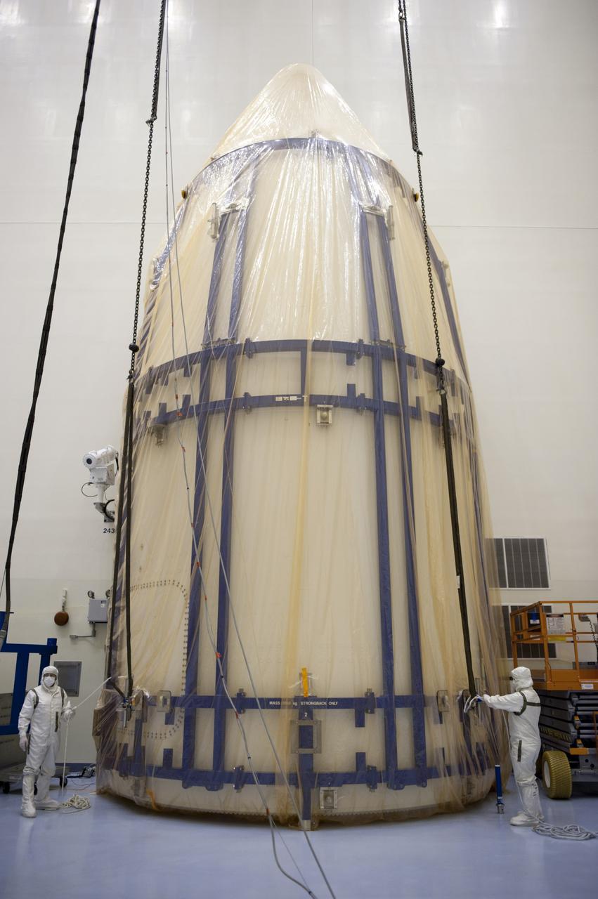 CAPE CANAVERAL, Fla. -- In the Payload Hazardous Servicing Facility at NASA's Kennedy Space Center in Florida, United Launch Alliance technicians prepare to lift half of the Atlas V payload fairing for NASA's Mars Science Laboratory (MSL) mission from the floor. Preparations are under way to lower it into a horizontal position to uncover and then clean it to meet NASA's planetary protection requirements. The fairing will protect the spacecraft from the impact of aerodynamic pressure and heating during ascent. Although jettisoned once the spacecraft is outside the Earth's atmosphere, the fairing must be cleaned to the same exacting standards as the laboratory to avoid the possibility of contaminating it. MSL's components include a compact car-sized rover, Curiosity, which has 10 science instruments designed to search for evidence on whether Mars has had environments favorable to microbial life, including the chemical ingredients for life. The unique rover will use a laser to look inside rocks and release its gasses so that the rover’s spectrometer can analyze and send the data back to Earth. Launch of MSL aboard a United Launch Alliance Atlas V rocket is planned for Nov. 25 from Space Launch Complex 41 on Cape Canaveral Air Force Station. For more information, visit http:__www.nasa.gov_msl. Photo credit: NASA_Kim Shiflett