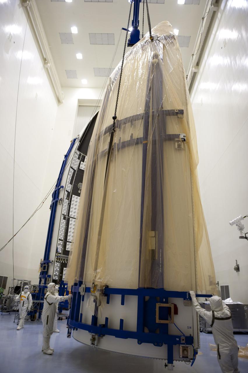 CAPE CANAVERAL, Fla. -- In the Payload Hazardous Servicing Facility at NASA's Kennedy Space Center in Florida, United Launch Alliance technicians steady half of the Atlas V payload fairing for NASA's Mars Science Laboratory (MSL) mission as it is lifted from the floor. Preparations are under way to lower it into a horizontal position to uncover and then clean it to meet NASA's planetary protection requirements. Behind it is the other half of the fairing, already uncovered.  The fairing will protect the spacecraft from the impact of aerodynamic pressure and heating during ascent.  Although jettisoned once the spacecraft is outside the Earth's atmosphere, the fairing must be cleaned to the same exacting standards as the laboratory to avoid the possibility of contaminating it. MSL's components include a compact car-sized rover, Curiosity, which has 10 science instruments designed to search for evidence on whether Mars has had environments favorable to microbial life, including the chemical ingredients for life. The unique rover will use a laser to look inside rocks and release its gasses so that the rover’s spectrometer can analyze and send the data back to Earth. Launch of MSL aboard a United Launch Alliance Atlas V rocket is planned for Nov. 25 from Space Launch Complex 41 on Cape Canaveral Air Force Station. For more information, visit http:__www.nasa.gov_msl. Photo credit: NASA_Kim Shiflett