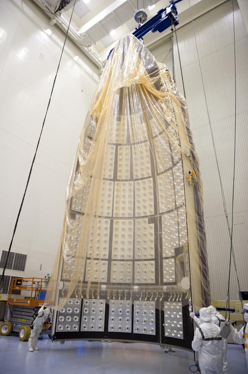 CAPE CANAVERAL, Fla. -- In the Payload Hazardous Servicing Facility at NASA's Kennedy Space Center in Florida, work is under way to lower half of the Atlas V payload fairing for NASA's Mars Science Laboratory (MSL) mission into a horizontal position. It then will be uncovered and cleaned to meet NASA's planetary protection requirements. The fairing will protect the spacecraft from the impact of aerodynamic pressure and heating during ascent. Although jettisoned once the spacecraft is outside the Earth's atmosphere, the fairing must be cleaned to the same exacting standards as the laboratory to avoid the possibility of contaminating it. MSL's components include a compact car-sized rover, Curiosity, which has 10 science instruments designed to search for evidence on whether Mars has had environments favorable to microbial life, including the chemical ingredients for life. The unique rover will use a laser to look inside rocks and release its gasses so that the rover’s spectrometer can analyze and send the data back to Earth. Launch of MSL aboard a United Launch Alliance Atlas V rocket is planned for Nov. 25 from Space Launch Complex 41 on Cape Canaveral Air Force Station. For more information, visit http:__www.nasa.gov_msl. Photo credit: NASA_Kim Shiflett