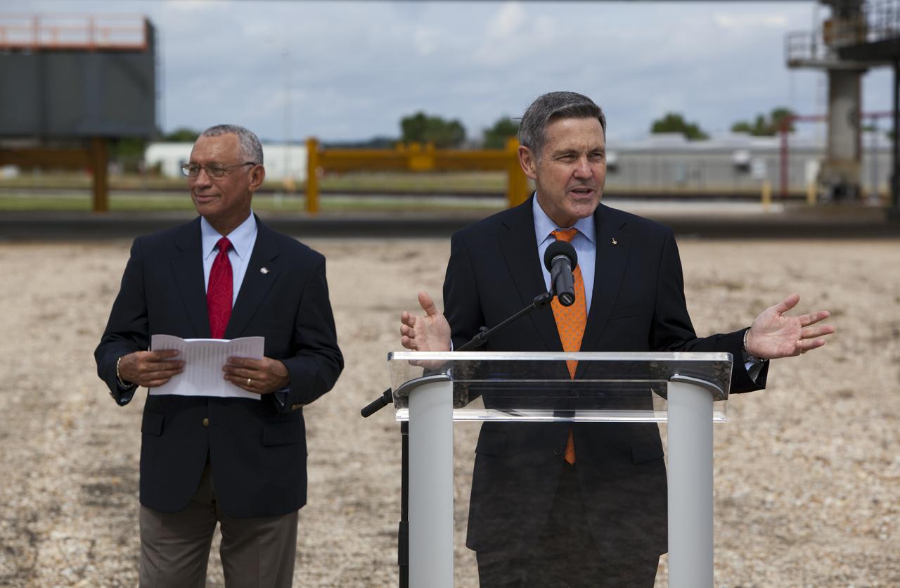 CAPE CANAVERAL, Fla. –At Kennedy Space Center in Florida, Center Director Bob Cabana talks to media near NASA’s mobile launcher (ML) support structure. The media event was held to detail ML’s use with NASA’s Space Launch System (SLS) heavy-lift rocket, which will take astronauts into deep space on missions to asteroids, the moon or Mars. Standing to the left of the podium is NASA Administrator Charlie Bolden.   It took about two years to construct the 355-foot-tall ML structure, which will support NASA's future human spaceflight program. The ML can be outfitted with ground support equipment, such as umbilicals and access arms, for future rocket launches. Photo credit: NASA_Dimitri Gerondidakis