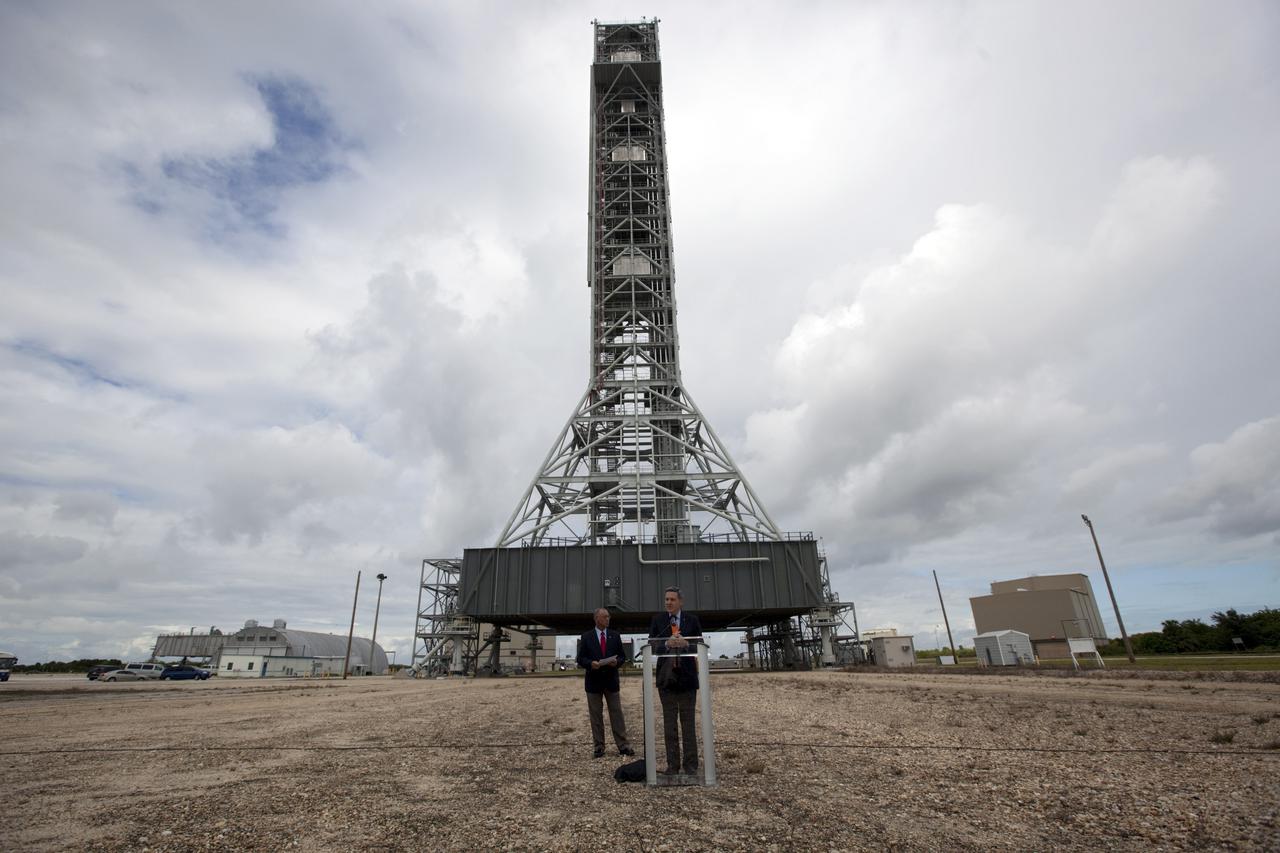 CAPE CANAVERAL, Fla. – At Kennedy Space Center in Florida, Center Director Bob Cabana talks to media in front of NASA’s mobile launcher (ML) support structure. The media event was held to detail ML’s use with NASA’s Space Launch System (SLS) heavy-lift rocket, which will take astronauts into deep space on missions to asteroids, the moon or Mars. Standing to the left of the podium is NASA Administrator Charlie Bolden.   It took about two years to construct the 355-foot-tall ML structure, which will support NASA's future human spaceflight program. The ML can be outfitted with ground support equipment, such as umbilicals and access arms, for future rocket launches. Photo credit: NASA_Dimitri Gerondidakis