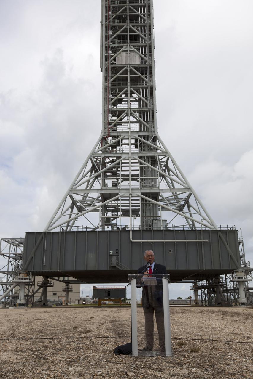 CAPE CANAVERAL, Fla. – At Kennedy Space Center in Florida, NASA Administrator Charlie Bolden talks to media in front of NASA’s mobile launcher (ML) support structure. Center Director Bob Cabana also attended the media event held to detail ML’s use with NASA’s Space Launch System (SLS) heavy-lift rocket, which will take astronauts into deep space on missions to asteroids, the moon or Mars.    It took about two years to construct the 355-foot-tall ML structure, which will support NASA's future human spaceflight program. The ML can be outfitted with ground support equipment, such as umbilicals and access arms, for future rocket launches. Photo credit: NASA_Dimitri Gerondidakis