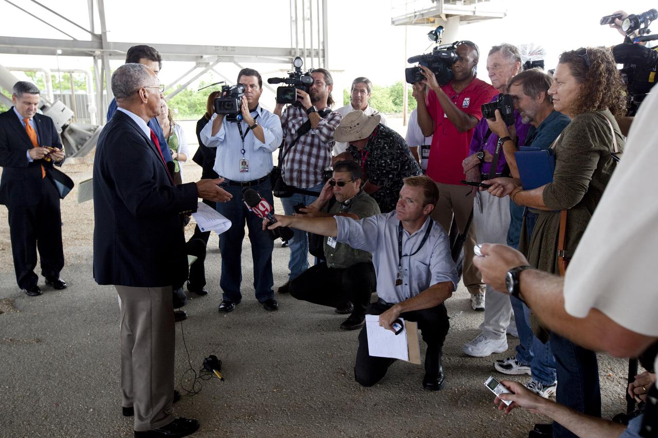 CAPE CANAVERAL, Fla. – At Kennedy Space Center in Florida, NASA Administrator Charlie Bolden talks to media underneath NASA’s mobile launcher (ML) support structure. Center Director Bob Cabana, at far left, also attended the media event held to detail ML’s use with NASA’s Space Launch System (SLS) heavy-lift rocket, which will take astronauts into deep space on missions to asteroids, the moon or Mars.    It took about two years to construct the 355-foot-tall ML structure, which will support NASA's future human spaceflight program. The ML can be outfitted with ground support equipment, such as umbilicals and access arms, for future rocket launches. Photo credit: NASA_Dimitri Gerondidakis