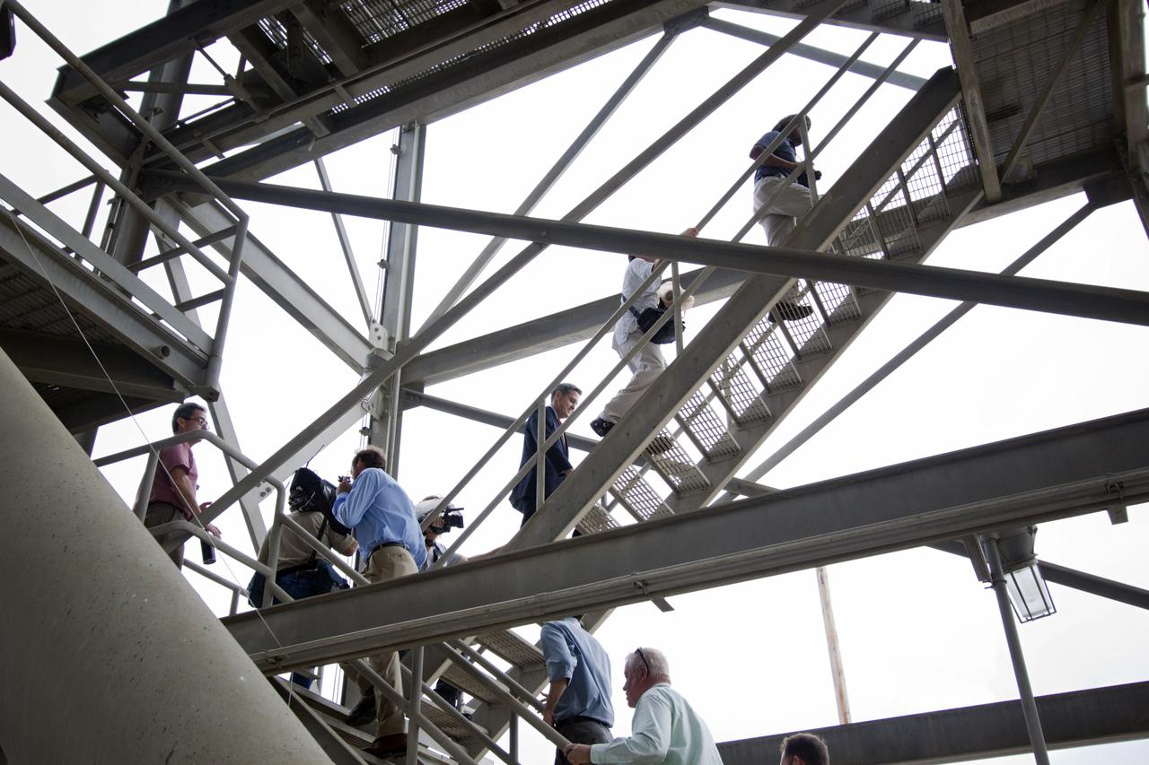 CAPE CANAVERAL, Fla. – At Kennedy Space Center in Florida, Center Director Bob Cabana (shown in the center of photo) and news media, climb the stairs of NASA’s mobile launcher (ML) support structure. A media event was held to detail ML’s use with NASA’s Space Launch System (SLS) heavy-lift rocket, which will take astronauts into deep space on missions to asteroids, the moon or Mars. NASA Administrator Charlie Bolden also was in attendance for the event.   It took about two years to construct the 355-foot-tall ML structure, which will support NASA's future human spaceflight program. The ML can be outfitted with ground support equipment, such as umbilicals and access arms, for future rocket launches. Photo credit: NASA_Jim Grossmann