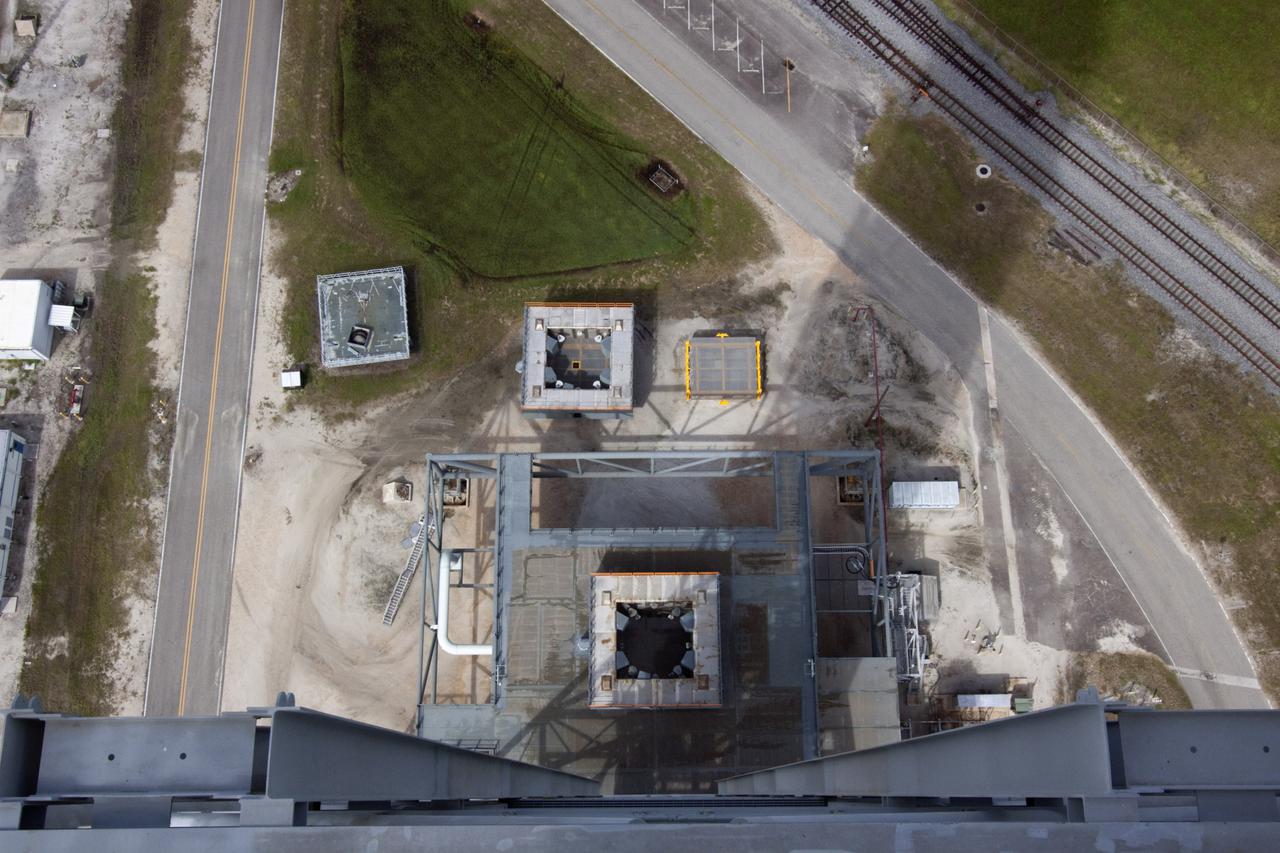 CAPE CANAVERAL, Fla. – The camera captures a unique view looking down from the top of NASA’s mobile launcher (ML) support structure at Kennedy Space Center in Florida. A media event was held on the grounds to detail ML’s use with NASA’s Space Launch System (SLS) heavy-lift rocket, which will take astronauts into deep space on missions to asteroids, the moon or Mars. NASA Administrator Charlie Bolden and Center Director Bob Cabana also were in attendance for the event.   It took about two years to construct the 355-foot-tall ML structure, which will support NASA's future human spaceflight program. The ML can be outfitted with ground support equipment, such as umbilicals and access arms, for future rocket launches. Photo credit: NASA_Jim Grossmann