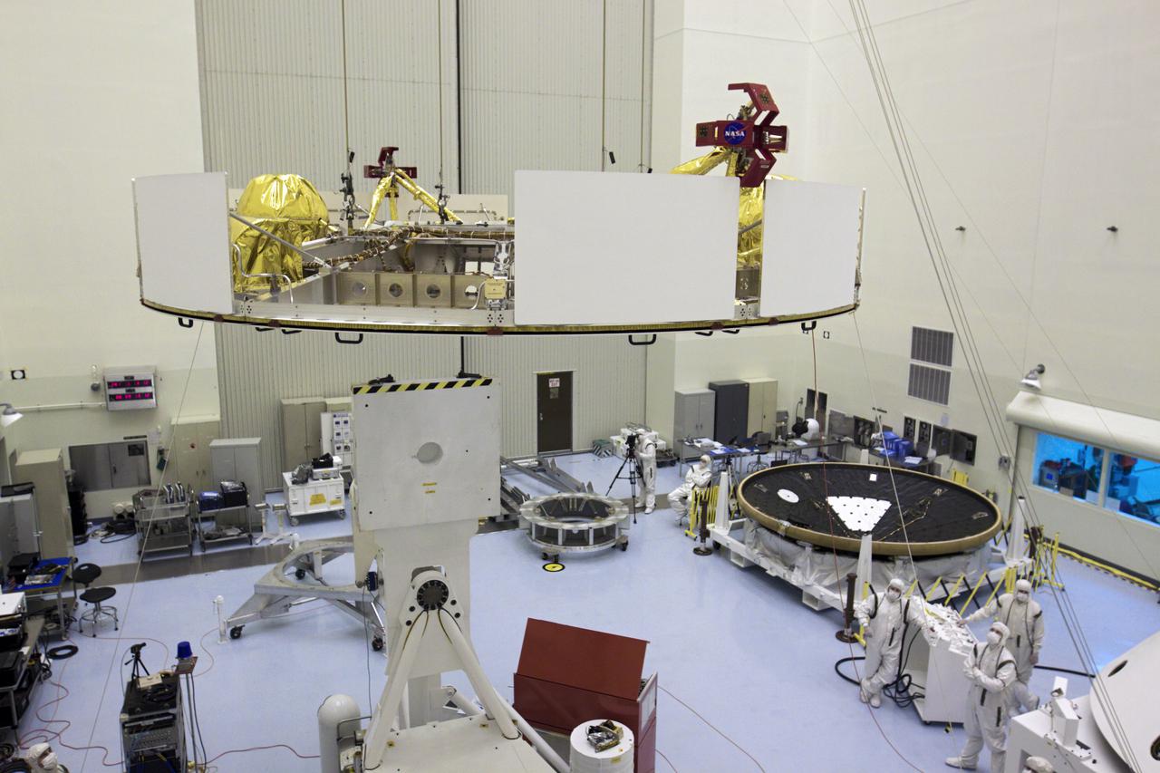 CAPE CANAVERAL, Fla. – In the Payload Hazardous Servicing Facility at NASA’s Kennedy Space Center in Florida, technicians, using an overhead crane, guide NASA's Mars Science Laboratory (MSL) mission cruise stage over a rotation stand. The cruise stage provides solar power, thrusters for navigation, and heat exchangers to the rover during its flight from Earth to Mars. To the right is the MSL heat shield. MSL's components include a car-sized rover, Curiosity, which has 10 science instruments designed to search for evidence on whether Mars has had environments favorable to microbial life, including chemical ingredients for life. The unique rover will use a laser to look inside rocks and release its gasses so that the rover’s spectrometer can analyze and send the data back to Earth. Launch of MSL aboard a United Launch Alliance Atlas V rocket is scheduled for Nov. 25 from Space Launch Complex 41 on Cape Canaveral Air Force Station in Florida. For more information, visit http:__www.nasa.gov_msl. Photo credit: NASA_Glenn Benson