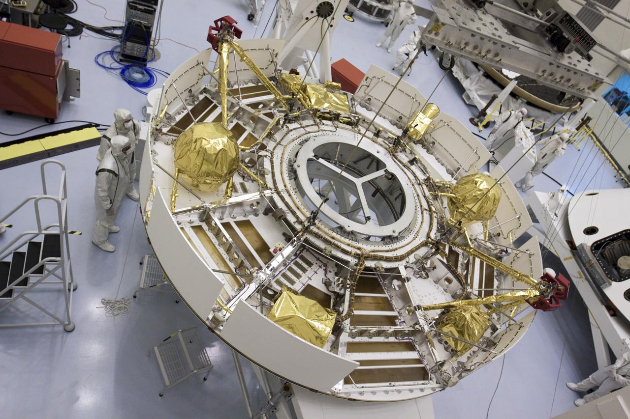 CAPE CANAVERAL, Fla. – In the Payload Hazardous Servicing Facility at NASA’s Kennedy Space Center in Florida, the camera captures a unique view of NASA's Mars Science Laboratory (MSL) mission cruise stage as technicians guide it onto a rotation stand using an overhead crane. The cruise stage provides solar power, thrusters for navigation, and heat exchangers to the rover during its flight from Earth to Mars. MSL's components include a car-sized rover, Curiosity, which has 10 science instruments designed to search for evidence on whether Mars has had environments favorable to microbial life, including chemical ingredients for life. The unique rover will use a laser to look inside rocks and release its gasses so that the rover’s spectrometer can analyze and send the data back to Earth. Launch of MSL aboard a United Launch Alliance Atlas V rocket is scheduled for Nov. 25 from Space Launch Complex 41 on Cape Canaveral Air Force Station in Florida. For more information, visit http:__www.nasa.gov_msl. Photo credit: NASA_Glenn Benson