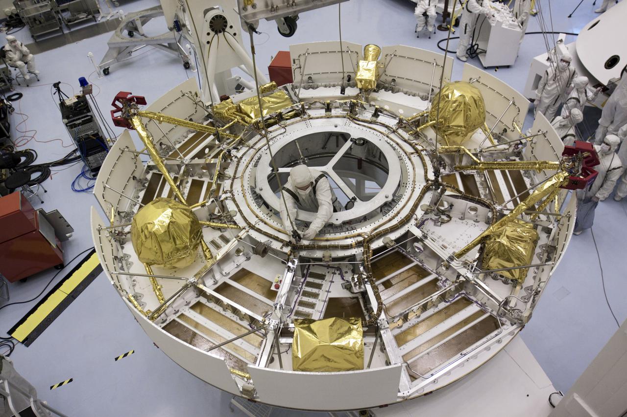 CAPE CANAVERAL, Fla. – In the Payload Hazardous Servicing Facility at NASA’s Kennedy Space Center in Florida, the camera captures a unique view of NASA's Mars Science Laboratory (MSL) mission as a technician separates the overhead crane from the cruise stage after it was lifted onto a rotation stand. The cruise stage provides solar power, thrusters for navigation, and heat exchangers to the rover during its flight from Earth to Mars. MSL's components include a car-sized rover, Curiosity, which has 10 science instruments designed to search for evidence on whether Mars has had environments favorable to microbial life, including chemical ingredients for life. The unique rover will use a laser to look inside rocks and release its gasses so that the rover’s spectrometer can analyze and send the data back to Earth. Launch of MSL aboard a United Launch Alliance Atlas V rocket is scheduled for Nov. 25 from Space Launch Complex 41 on Cape Canaveral Air Force Station in Florida. For more information, visit http:__www.nasa.gov_msl. Photo credit: NASA_Glenn Benson