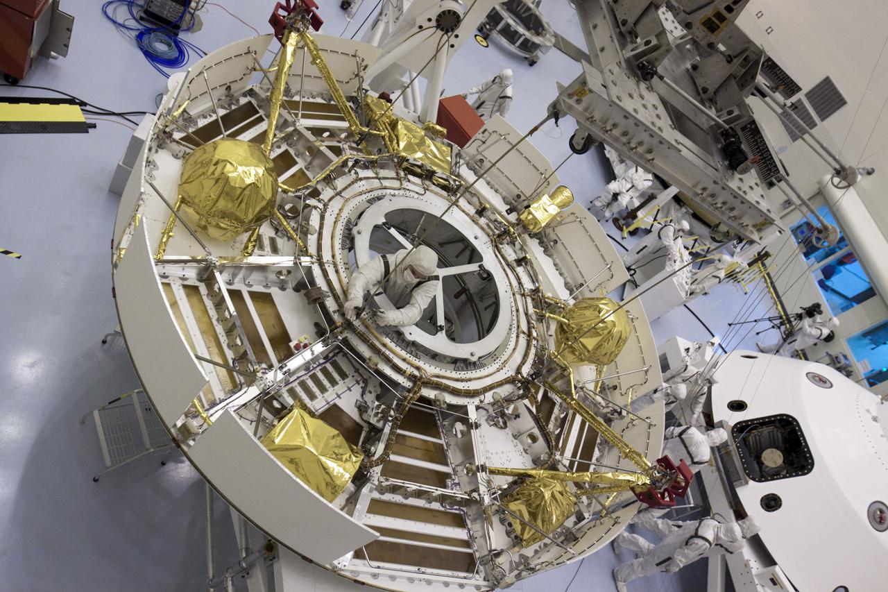 CAPE CANAVERAL, Fla. – In the Payload Hazardous Servicing Facility at NASA’s Kennedy Space Center in Florida, the camera captures a unique view of NASA's Mars Science Laboratory (MSL) mission as a technician separates the overhead crane from the cruise stage after it was lifted onto a rotation stand. The cruise stage provides solar power, thrusters for navigation, and heat exchangers to the rover during its flight from Earth to Mars. MSL's components include a car-sized rover, Curiosity, which has 10 science instruments designed to search for evidence on whether Mars has had environments favorable to microbial life, including chemical ingredients for life. The unique rover will use a laser to look inside rocks and release its gasses so that the rover’s spectrometer can analyze and send the data back to Earth. Launch of MSL aboard a United Launch Alliance Atlas V rocket is scheduled for Nov. 25 from Space Launch Complex 41 on Cape Canaveral Air Force Station in Florida. For more information, visit http:__www.nasa.gov_msl. Photo credit: NASA_Glenn Benson