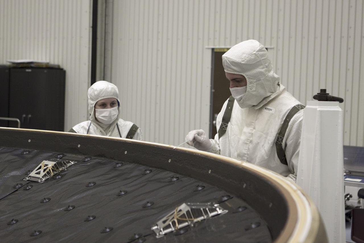 CAPE CANAVERAL, Fla. – In the Payload Hazardous Servicing Facility at NASA’s Kennedy Space Center in Florida, a technician cleans along the edge of NASA's Mars Science Laboratory (MSL) mission heat shield. MSL's components include a car-sized rover, Curiosity, which has 10 science instruments designed to search for evidence on whether Mars has had environments favorable to microbial life, including chemical ingredients for life. The unique rover will use a laser to look inside rocks and release its gasses so that the rover’s spectrometer can analyze and send the data back to Earth. Launch of MSL aboard a United Launch Alliance Atlas V rocket is scheduled for Nov. 25 from Space Launch Complex 41 on Cape Canaveral Air Force Station in Florida. For more information, visit http:__www.nasa.gov_msl. Photo credit: NASA_Glenn Benson