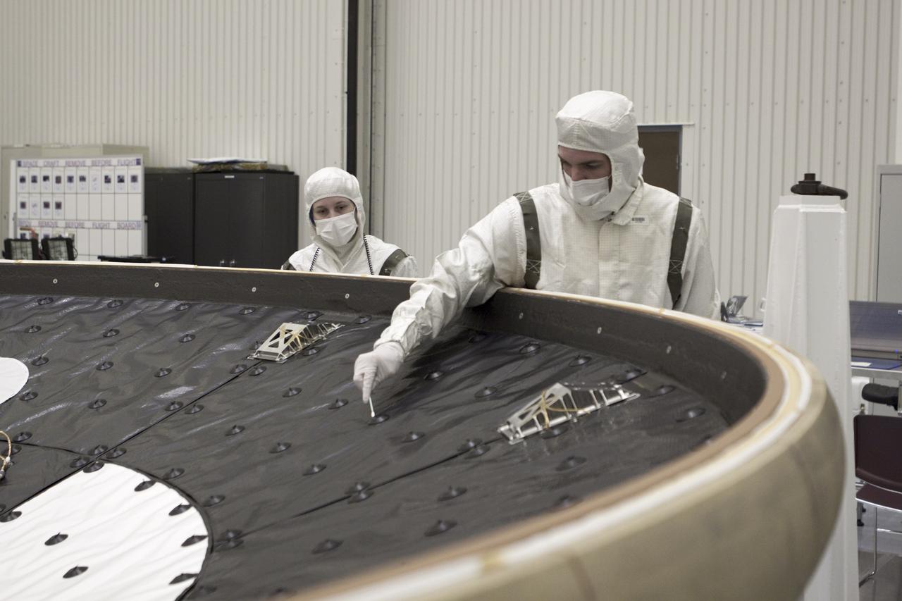 CAPE CANAVERAL, Fla. – In the Payload Hazardous Servicing Facility at NASA’s Kennedy Space Center in Florida, a technician cleans along the edge of NASA's Mars Science Laboratory (MSL) mission heat shield. MSL's components include a car-sized rover, Curiosity, which has 10 science instruments designed to search for evidence on whether Mars has had environments favorable to microbial life, including chemical ingredients for life. The unique rover will use a laser to look inside rocks and release its gasses so that the rover’s spectrometer can analyze and send the data back to Earth. Launch of MSL aboard a United Launch Alliance Atlas V rocket is scheduled for Nov. 25 from Space Launch Complex 41 on Cape Canaveral Air Force Station in Florida. For more information, visit http:__www.nasa.gov_msl. Photo credit: NASA_Glenn Benson