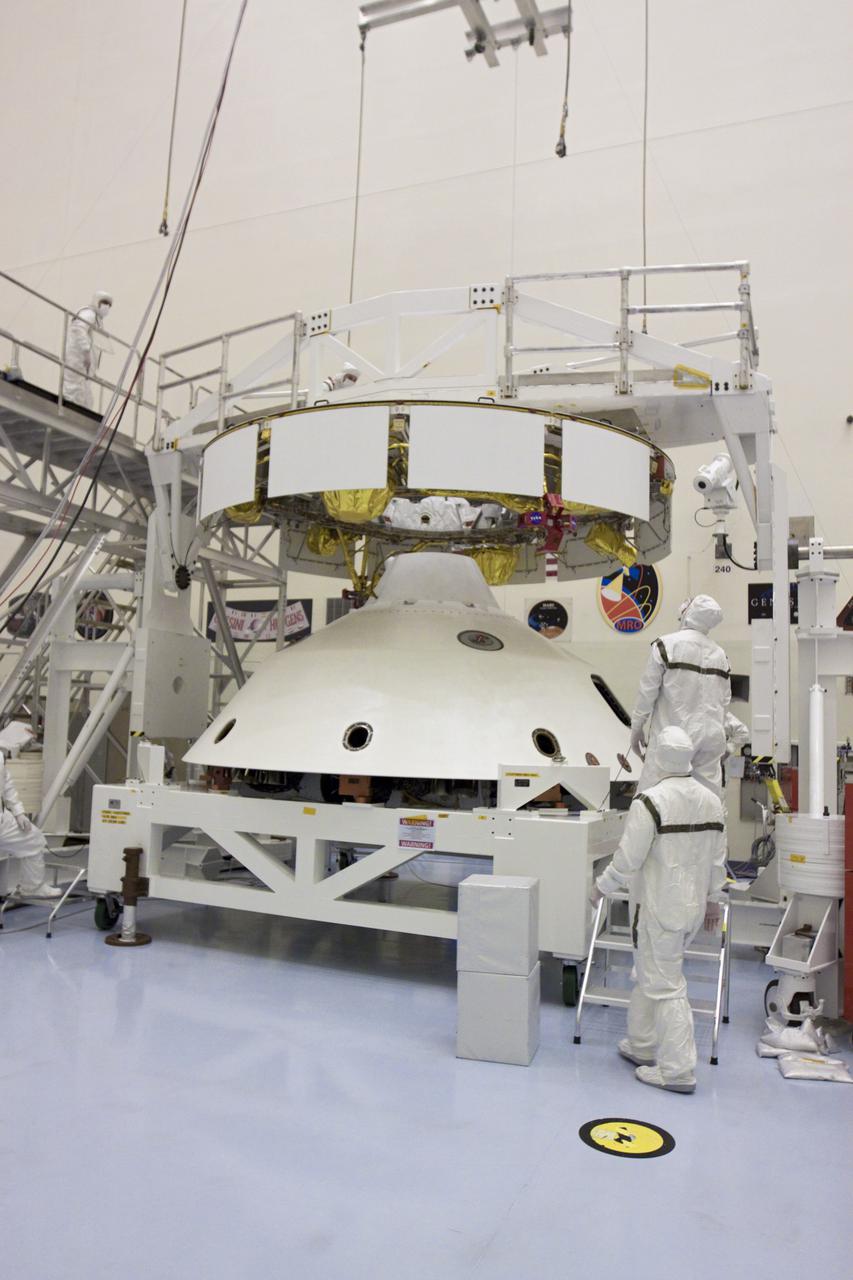 CAPE CANAVERAL, Fla. – In the Payload Hazardous Servicing Facility at NASA’s Kennedy Space Center in Florida, technicians prepare to attach an overhead crane to NASA's Mars Science Laboratory (MSL) mission aeroshell, (containing the compact car-sized rover Curiosity), which will be mated to the cruise stage. The cruise stage provides solar power, thrusters for navigation, and heat exchangers to the rover during its flight from Earth to Mars. The rover Curiosity has 10 science instruments designed to search for evidence on whether Mars has had environments favorable to microbial life, including chemical ingredients for life. The unique rover will use a laser to look inside rocks and release its gasses so that the rover’s spectrometer can analyze and send the data back to Earth. Launch of MSL aboard a United Launch Alliance Atlas V rocket is scheduled for Nov. 25 from Space Launch Complex 41 on Cape Canaveral Air Force Station in Florida. For more information, visit http:__www.nasa.gov_msl. Photo credit: NASA_Glenn Benson