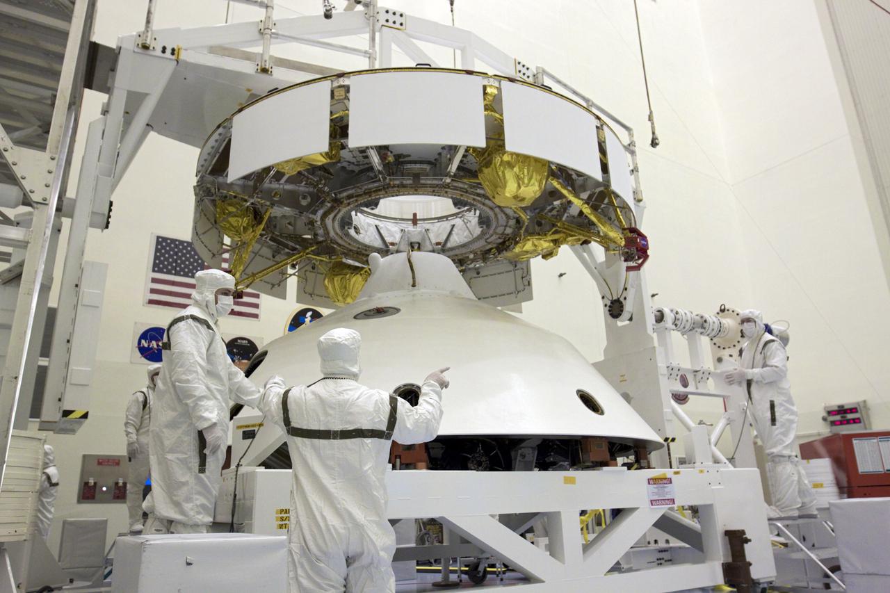 CAPE CANAVERAL, Fla. – In the Payload Hazardous Servicing Facility at NASA’s Kennedy Space Center in Florida, technicians prepare to attach an overhead crane to NASA's Mars Science Laboratory (MSL) mission aeroshell, (containing the compact car-sized rover Curiosity), which will be mated to the cruise stage. The cruise stage provides solar power, thrusters for navigation, and heat exchangers to the rover during its flight from Earth to Mars. The rover Curiosity has 10 science instruments designed to search for evidence on whether Mars has had environments favorable to microbial life, including chemical ingredients for life. The unique rover will use a laser to look inside rocks and release its gasses so that the rover’s spectrometer can analyze and send the data back to Earth. Launch of MSL aboard a United Launch Alliance Atlas V rocket is scheduled for Nov. 25 from Space Launch Complex 41 on Cape Canaveral Air Force Station in Florida. For more information, visit http:__www.nasa.gov_msl. Photo credit: NASA_Glenn Benson
