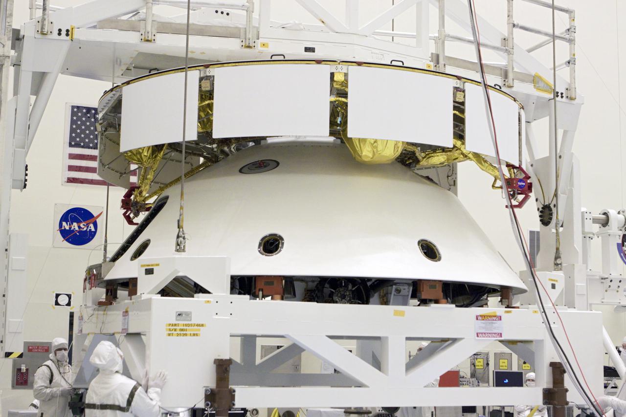 CAPE CANAVERAL, Fla. – In the Payload Hazardous Servicing Facility at NASA’s Kennedy Space Center in Florida, technicians, using an overhead crane, lift NASA's Mars Science Laboratory (MSL) mission aeroshell, (containing the compact car-sized rover Curiosity), for mating to the cruise stage. The cruise stage provides solar power, thrusters for navigation, and heat exchangers to the rover during its flight from Earth to Mars.   The rover Curiosity has 10 science instruments designed to search for evidence on whether Mars has had environments favorable to microbial life, including chemical ingredients for life.  The unique rover will use a laser to look inside rocks and release its gasses so that the rover’s spectrometer can analyze and send the data back to Earth. Launch of MSL aboard a United Launch Alliance Atlas V rocket is scheduled for Nov. 25 from Space Launch Complex 41 on Cape Canaveral Air Force Station in Florida. For more information, visit http:__www.nasa.gov_msl. Photo credit: NASA_Glenn Benson