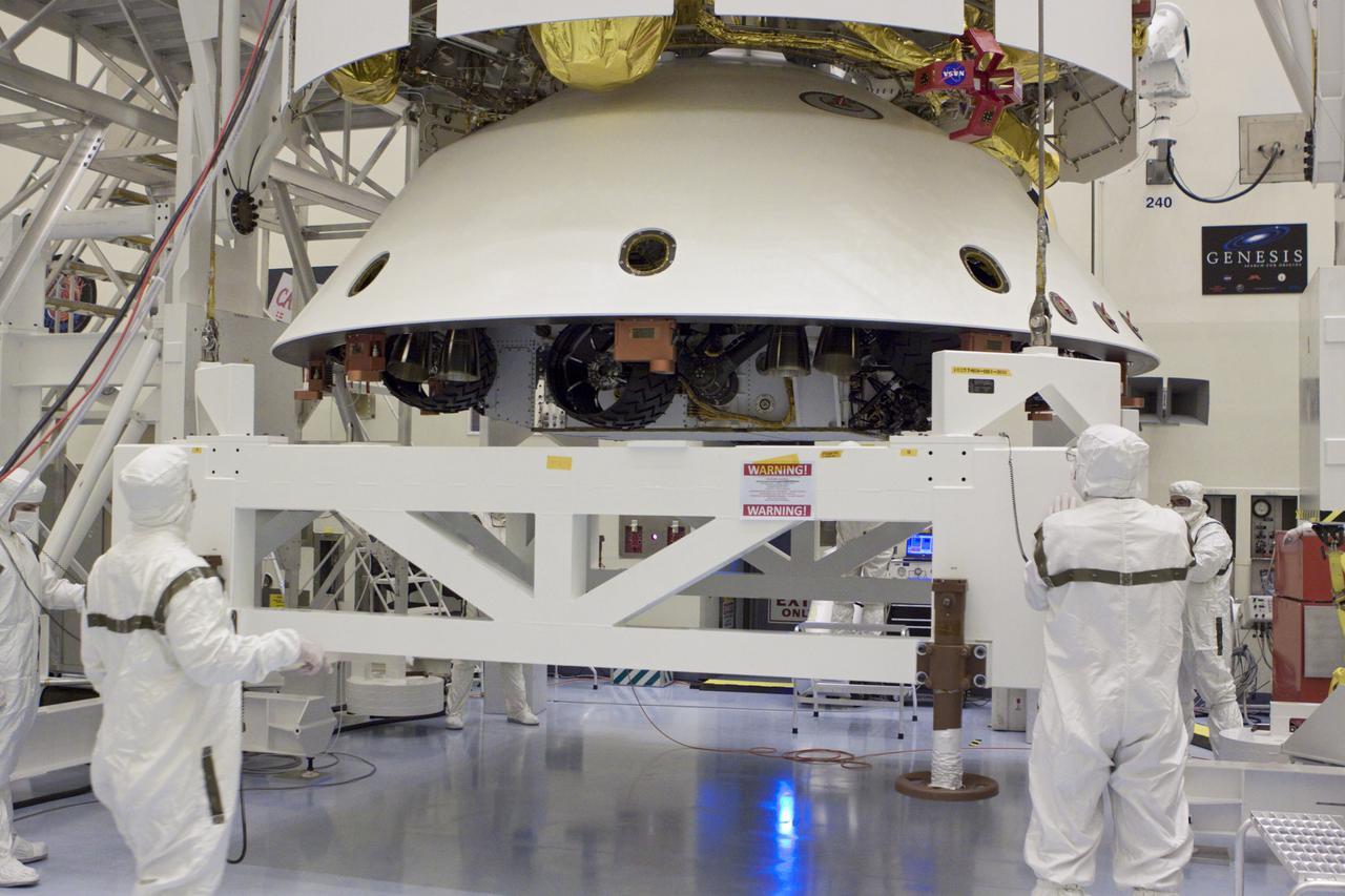 CAPE CANAVERAL, Fla. – In the Payload Hazardous Servicing Facility at NASA’s Kennedy Space Center in Florida, technicians, using an overhead crane, lift NASA's Mars Science Laboratory (MSL) mission aeroshell, (containing the compact car-sized rover Curiosity), for mating to the cruise stage. The cruise stage provides solar power, thrusters for navigation, and heat exchangers to the rover during its flight from Earth to Mars. The rover Curiosity has 10 science instruments designed to search for evidence on whether Mars has had environments favorable to microbial life, including chemical ingredients for life. The unique rover will use a laser to look inside rocks and release its gasses so that the rover’s spectrometer can analyze and send the data back to Earth. Launch of MSL aboard a United Launch Alliance Atlas V rocket is scheduled for Nov. 25 from Space Launch Complex 41 on Cape Canaveral Air Force Station in Florida. For more information, visit http:__www.nasa.gov_msl. Photo credit: NASA_Glenn Benson