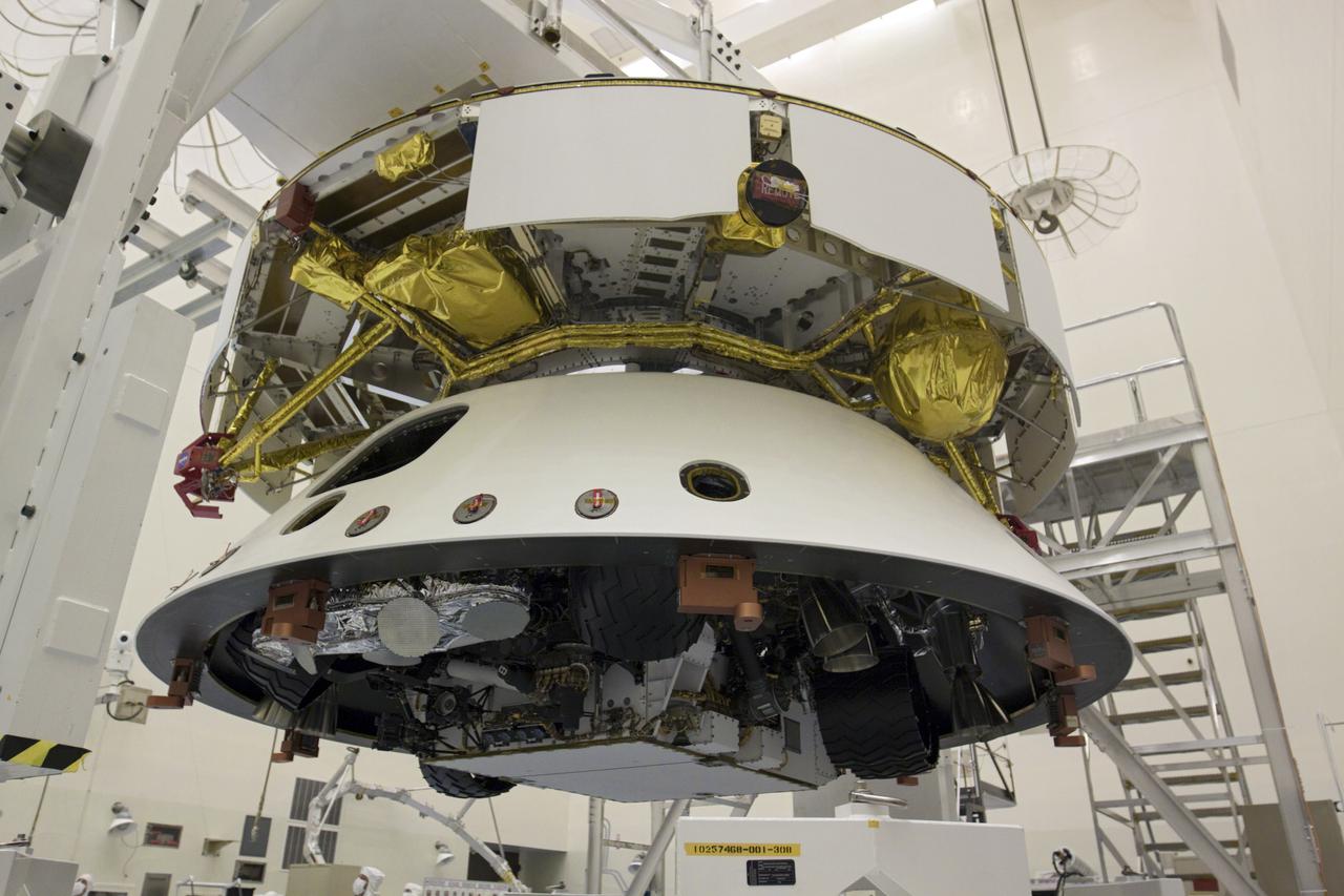 CAPE CANAVERAL, Fla. – In the Payload Hazardous Servicing Facility at NASA’s Kennedy Space Center in Florida, NASA's Mars Science Laboratory (MSL) mission aeroshell, (containing the compact car-sized rover Curiosity), has been mated to the cruise stage. The cruise stage provides solar power, thrusters for navigation, and heat exchangers to the rover during its flight from Earth to Mars.   The rover Curiosity has 10 science instruments designed to search for evidence on whether Mars has had environments favorable to microbial life, including chemical ingredients for life.  The unique rover will use a laser to look inside rocks and release its gasses so that the rover’s spectrometer can analyze and send the data back to Earth. Launch of MSL aboard a United Launch Alliance Atlas V rocket is scheduled for Nov. 25 from Space Launch Complex 41 on Cape Canaveral Air Force Station in Florida. For more information, visit http:__www.nasa.gov_msl. Photo credit: NASA_Glenn Benson