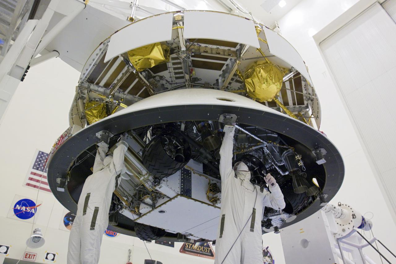 CAPE CANAVERAL, Fla. – In the Payload Hazardous Servicing Facility at NASA’s Kennedy Space Center in Florida, technicians work beneath NASA's Mars Science Laboratory (MSL) mission aeroshell, (containing the compact car-sized rover Curiosity), which has been mated to the cruise stage. The cruise stage provides solar power, thrusters for navigation, and heat exchangers to the rover during its flight from Earth to Mars. The rover Curiosity has 10 science instruments designed to search for evidence on whether Mars has had environments favorable to microbial life, including chemical ingredients for life. The unique rover will use a laser to look inside rocks and release its gasses so that the rover’s spectrometer can analyze and send the data back to Earth. Launch of MSL aboard a United Launch Alliance Atlas V rocket is scheduled for Nov. 25 from Space Launch Complex 41 on Cape Canaveral Air Force Station in Florida. For more information, visit http:__www.nasa.gov_msl. Photo credit: NASA_Glenn Benson