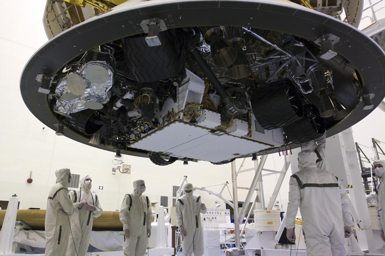CAPE CANAVERAL, Fla. – In the Payload Hazardous Servicing Facility at NASA’s Kennedy Space Center in Florida, technicians work beneath NASA's Mars Science Laboratory (MSL) mission aeroshell, (containing the compact car-sized rover Curiosity), which has been mated to the cruise stage. The cruise stage provides solar power, thrusters for navigation, and heat exchangers to the rover during its flight from Earth to Mars. The rover Curiosity has 10 science instruments designed to search for evidence on whether Mars has had environments favorable to microbial life, including chemical ingredients for life. The unique rover will use a laser to look inside rocks and release its gasses so that the rover’s spectrometer can analyze and send the data back to Earth. Launch of MSL aboard a United Launch Alliance Atlas V rocket is scheduled for Nov. 25 from Space Launch Complex 41 on Cape Canaveral Air Force Station in Florida. For more information, visit http:__www.nasa.gov_msl. Photo credit: NASA_Glenn Benson